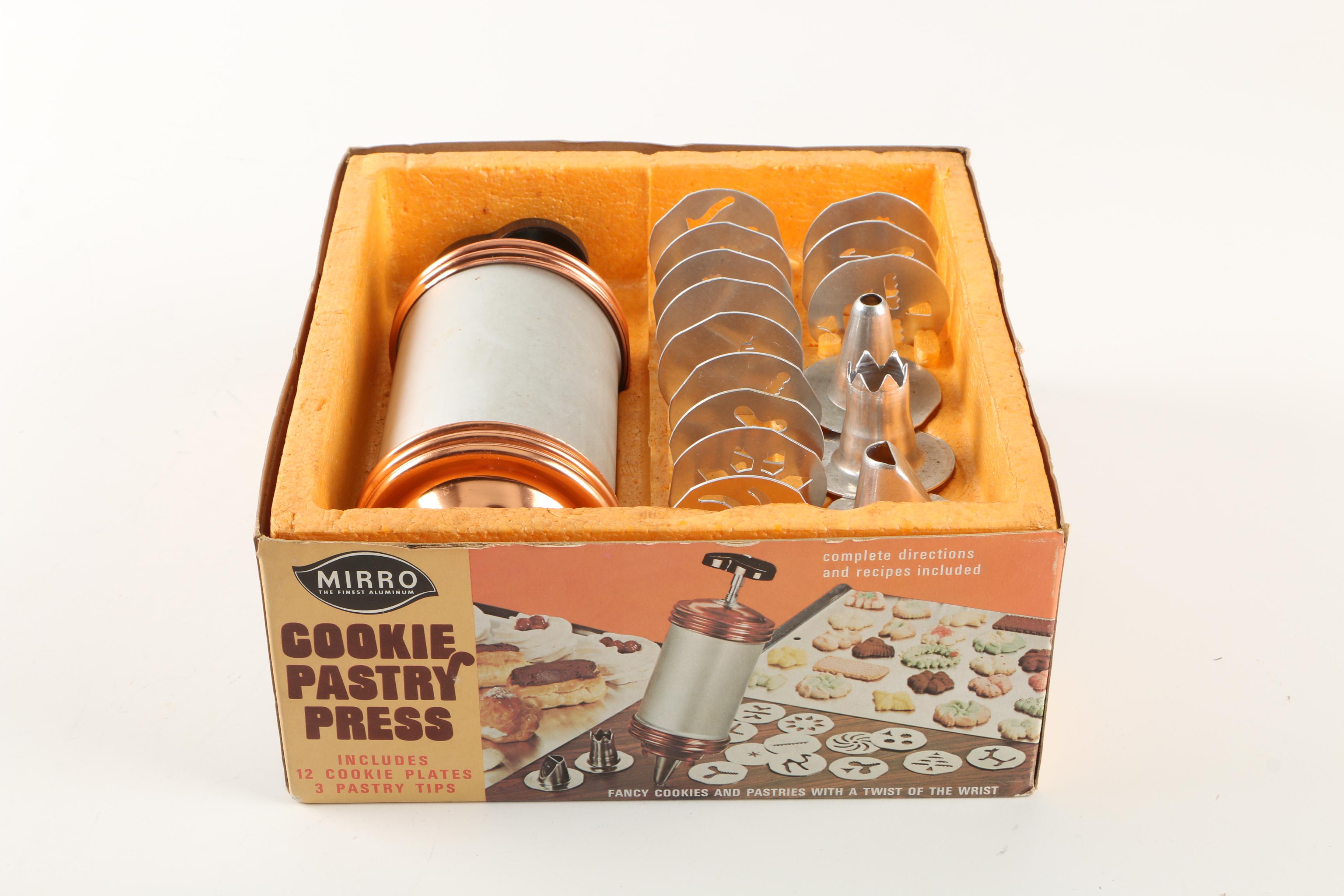 Assortment of kitchenwares featuring a Mirro cookie pastry press