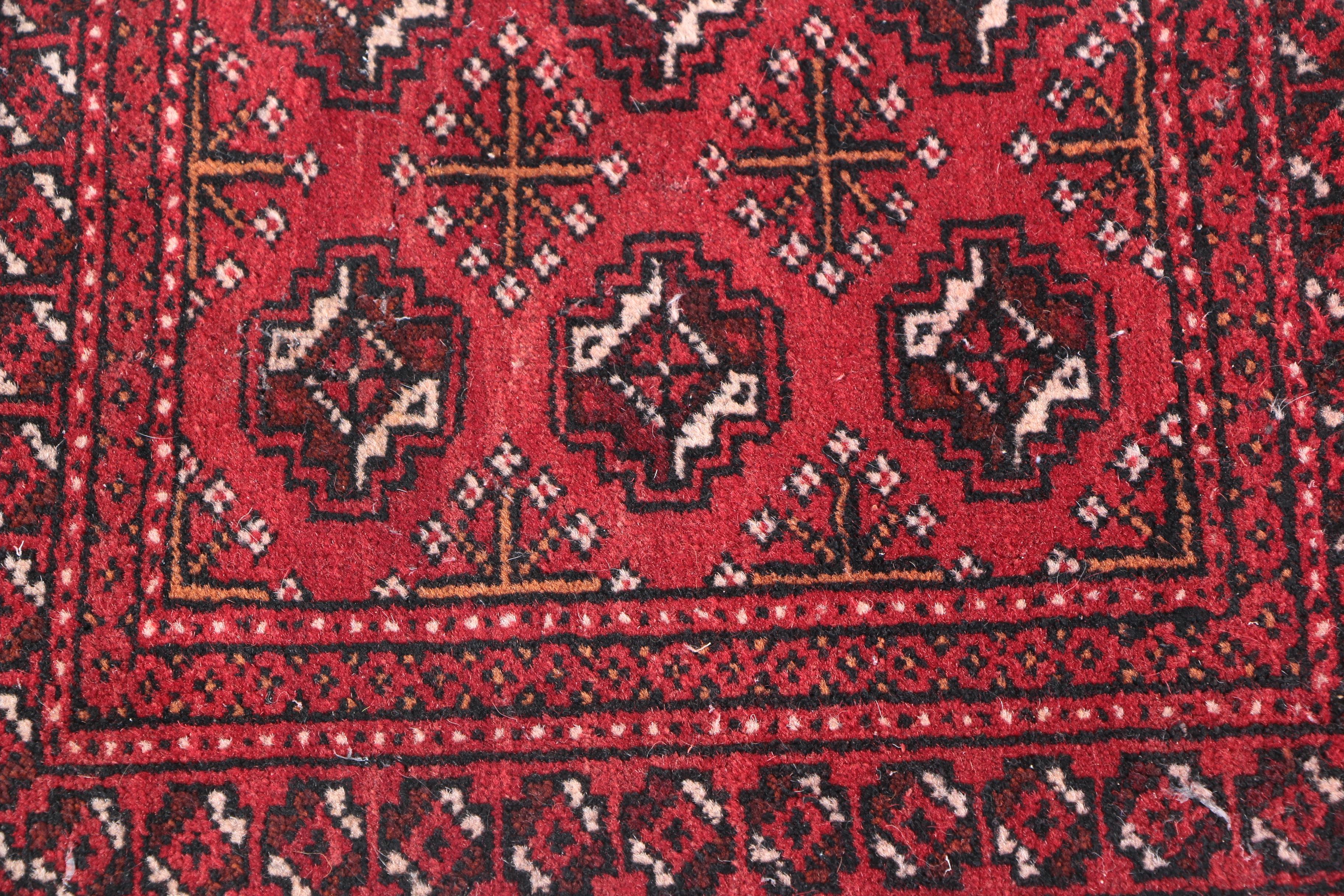 Hand-Knotted Turkmen Bokhara Wool Accent Rug and a Handwoven Saddle Bag