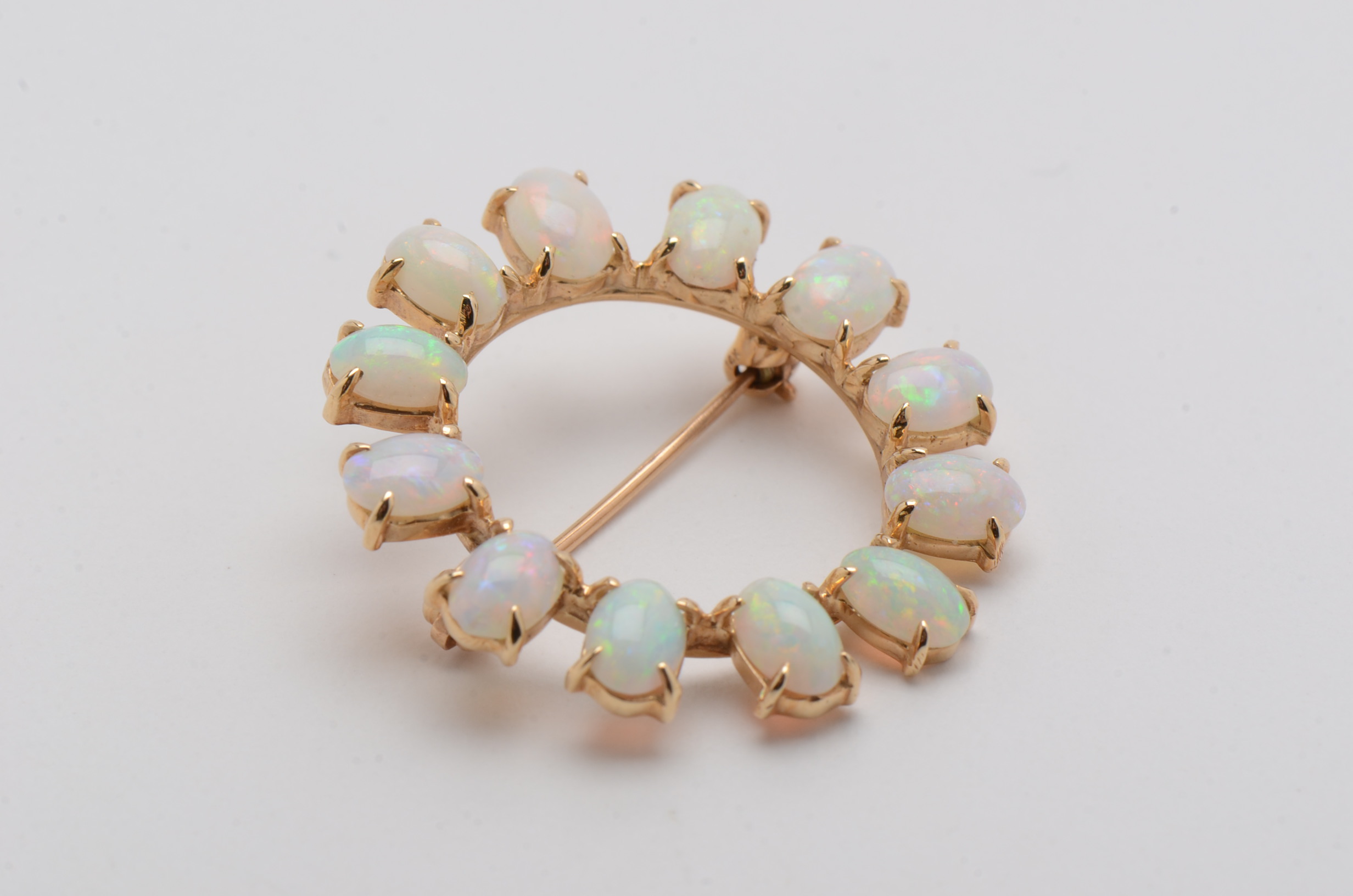 14K Yellow Gold Circle Brooch with Twelve Prong Set Opals