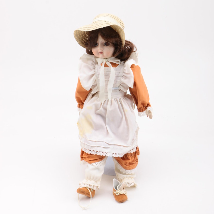 Bisque Doll Wearing Orange Jumpsuit and White Pinafore