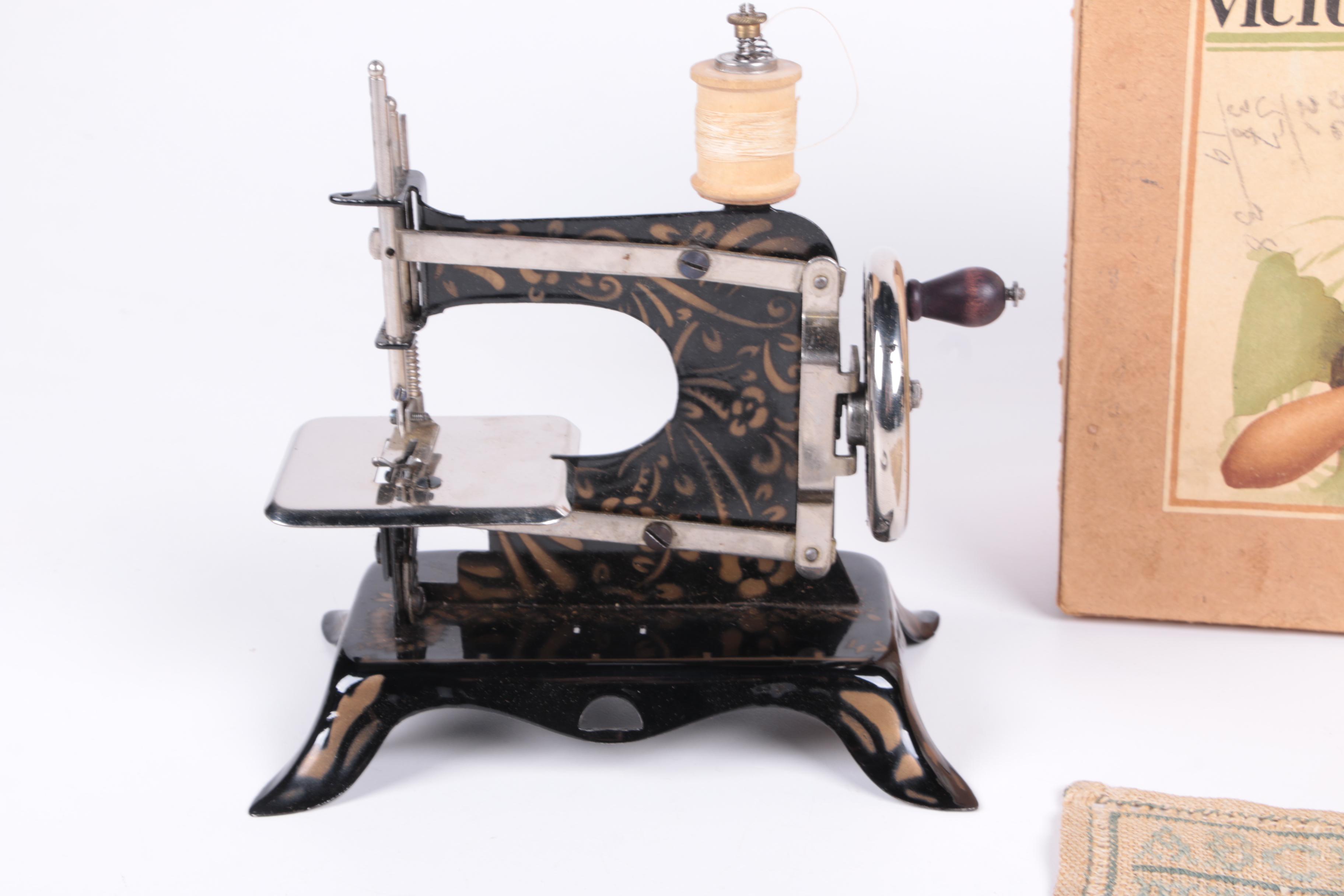 Ernst Plank Toy Sewing Machine with Box and Embroidered Sampler