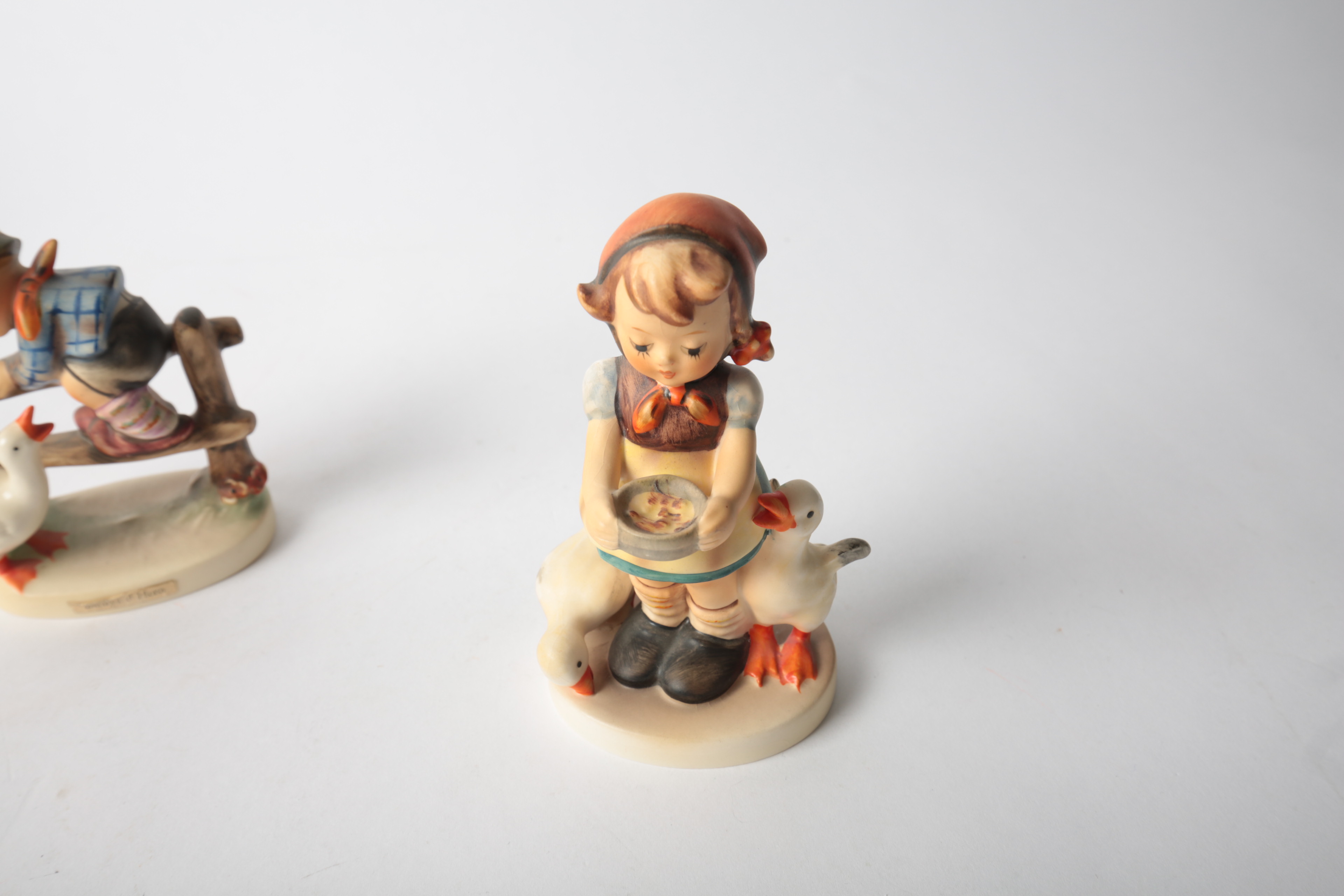 Pair of Porcelain Goebel Hummel Figurines "Be Patient" and "Barnyard Hero"