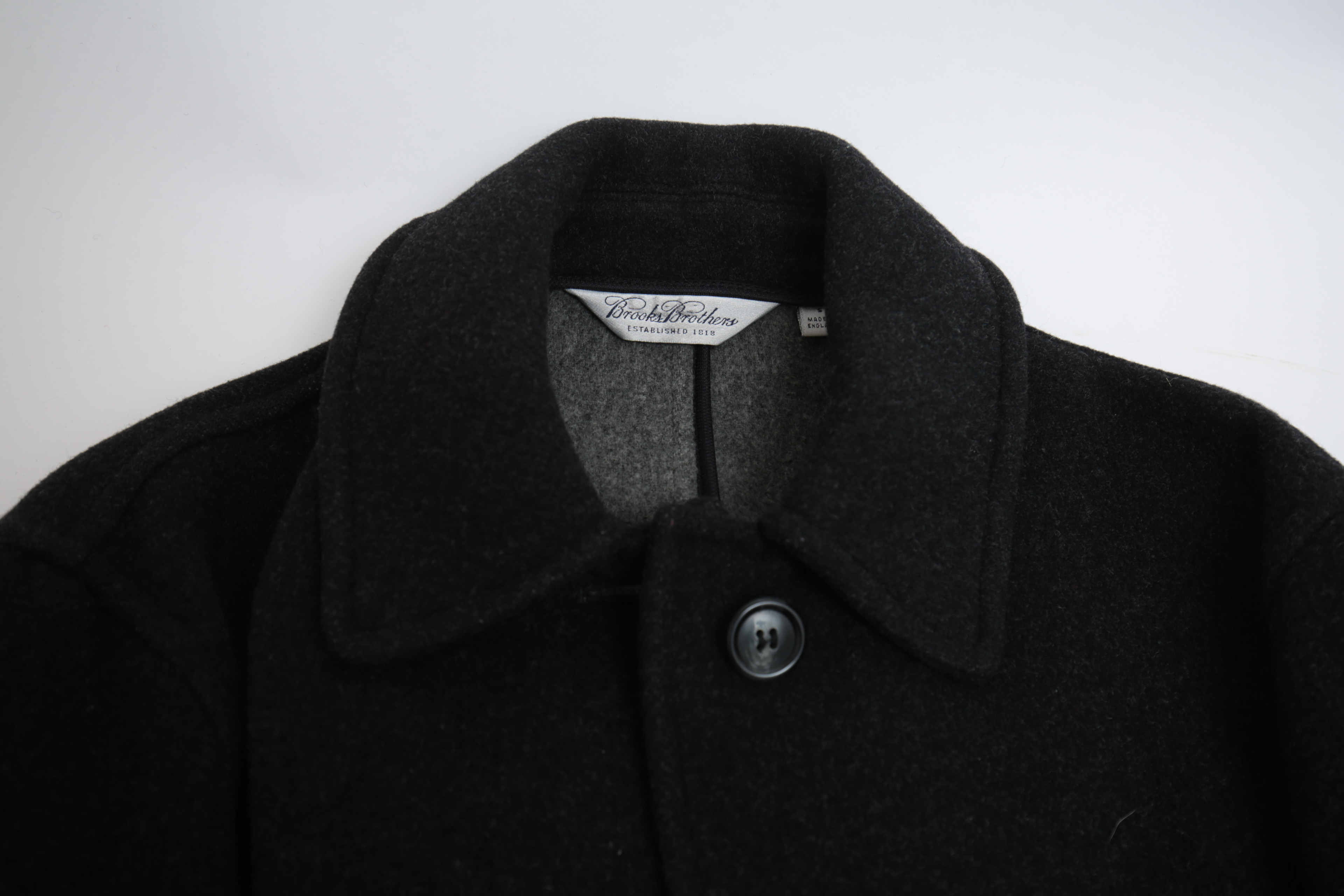 Collection of Black and White Coats Featuring Geiger and Brooks Brothers