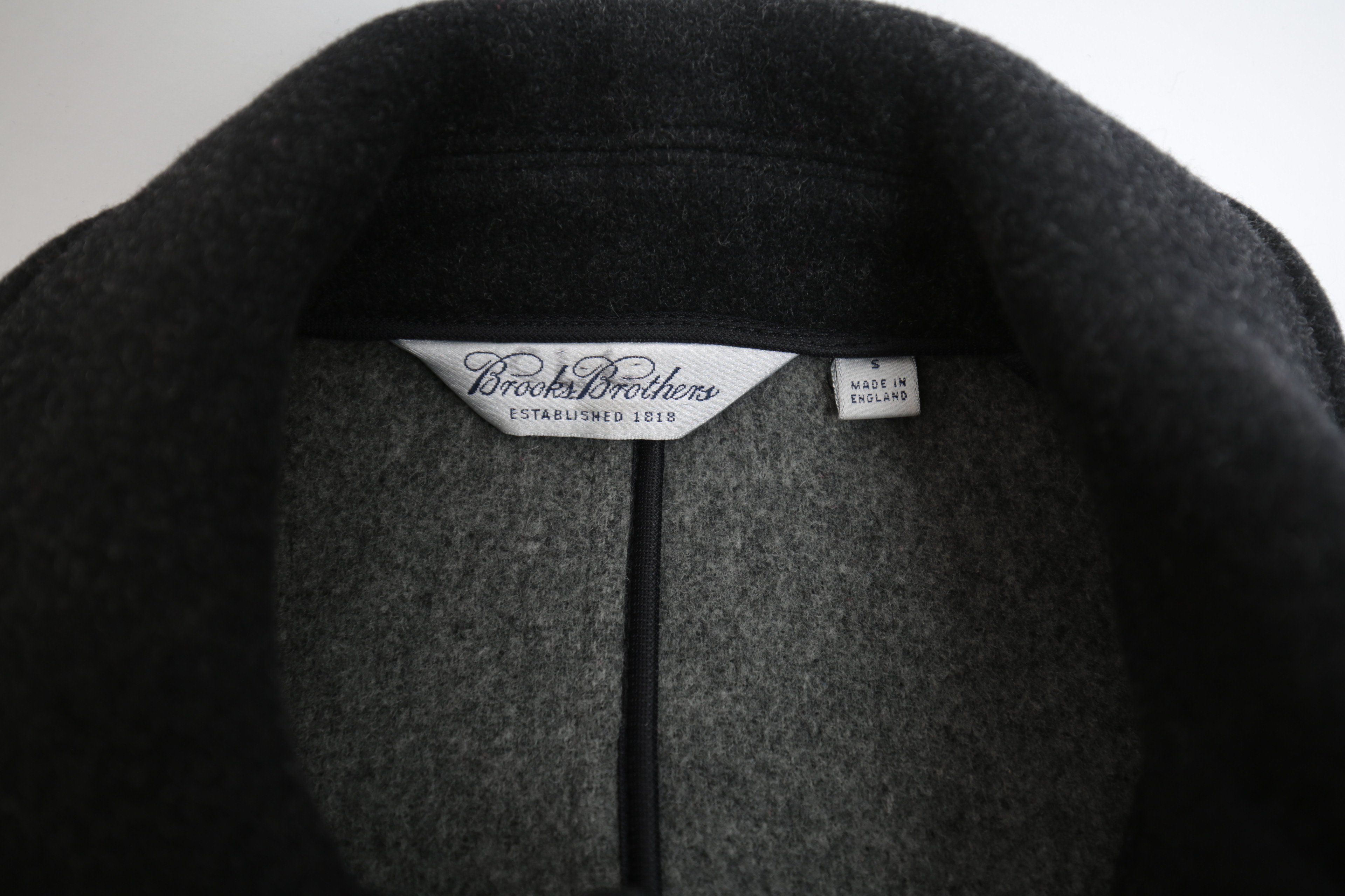 Collection of Black and White Coats Featuring Geiger and Brooks Brothers