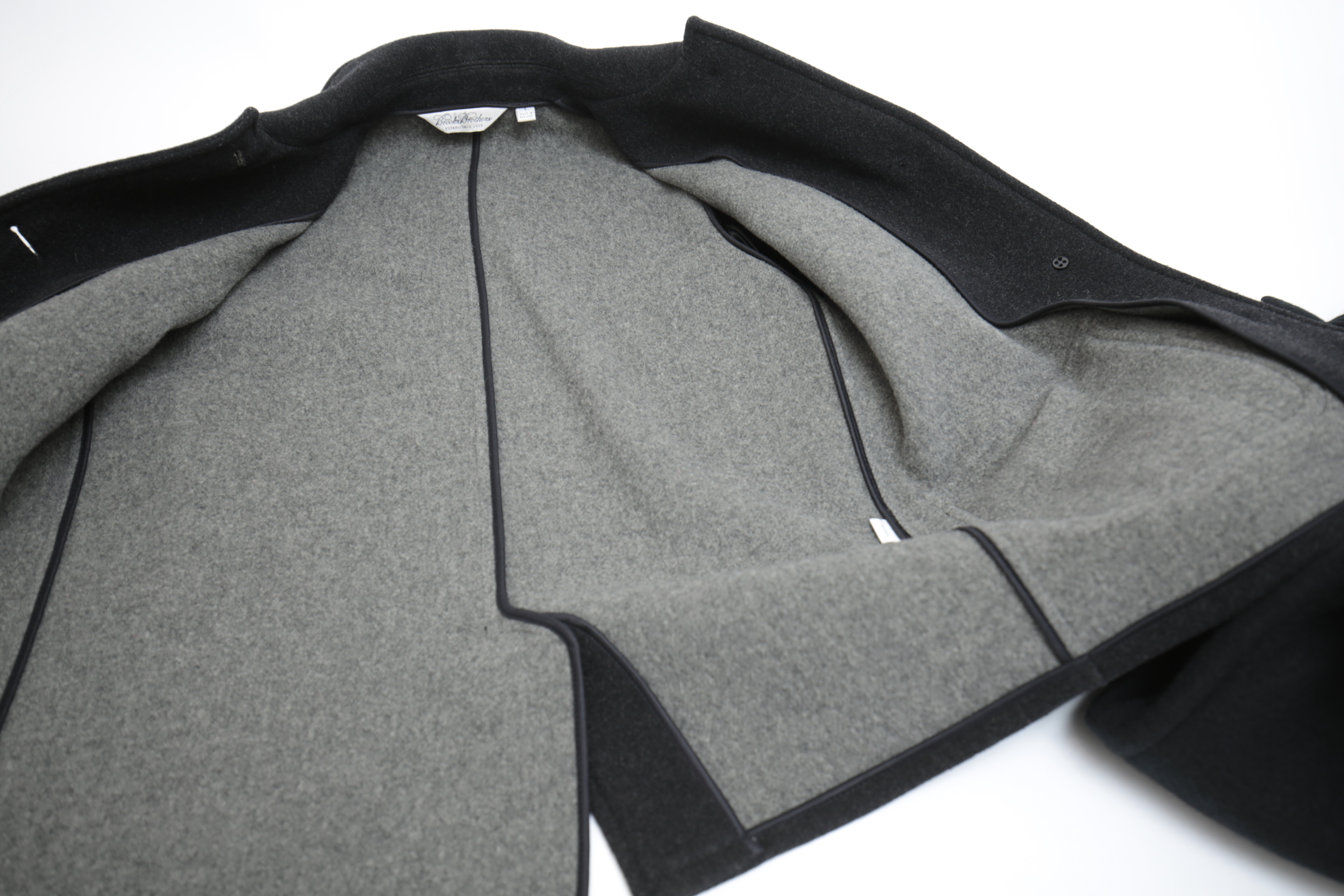 Collection of Black and White Coats Featuring Geiger and Brooks Brothers