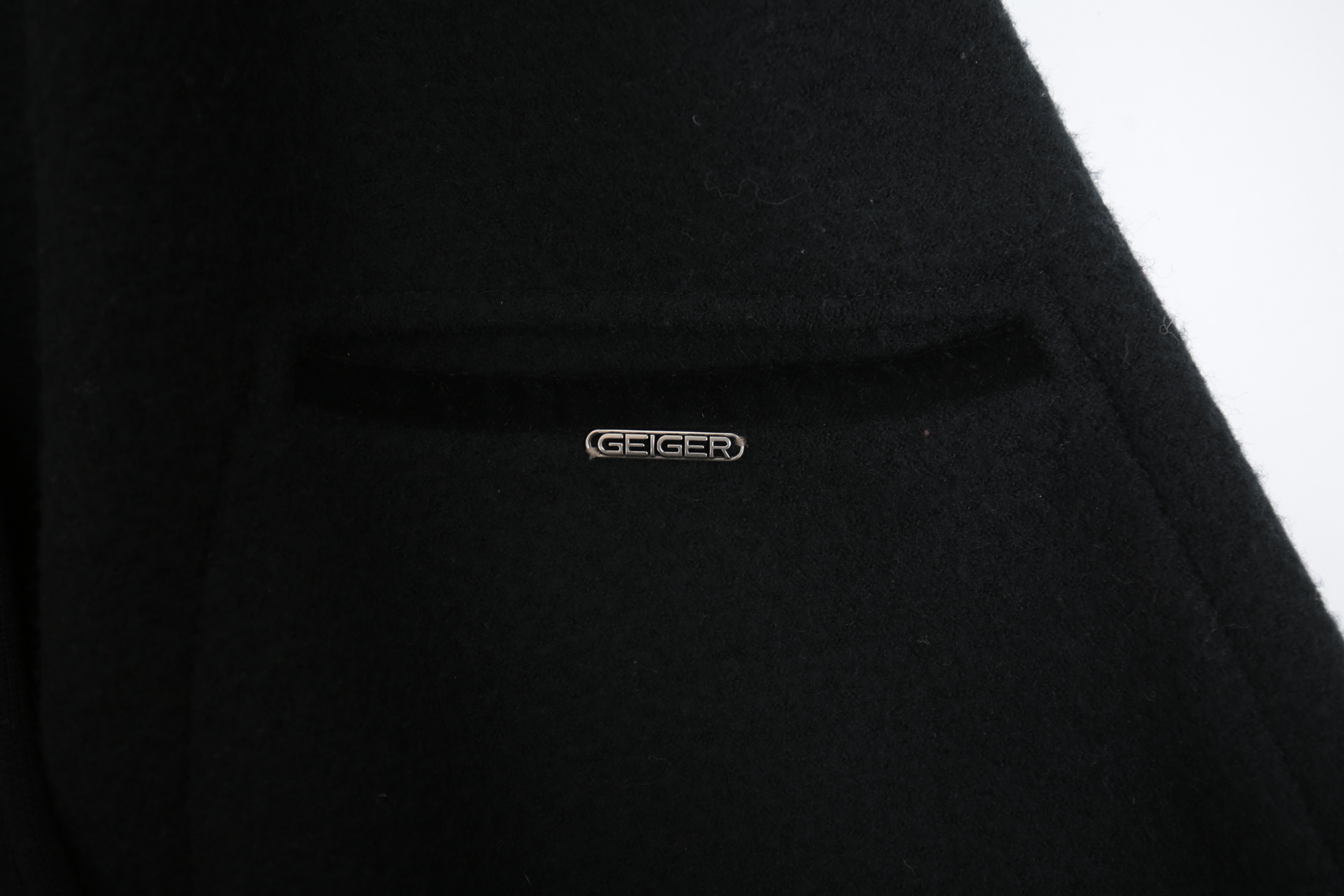 Collection of Black and White Coats Featuring Geiger and Brooks Brothers