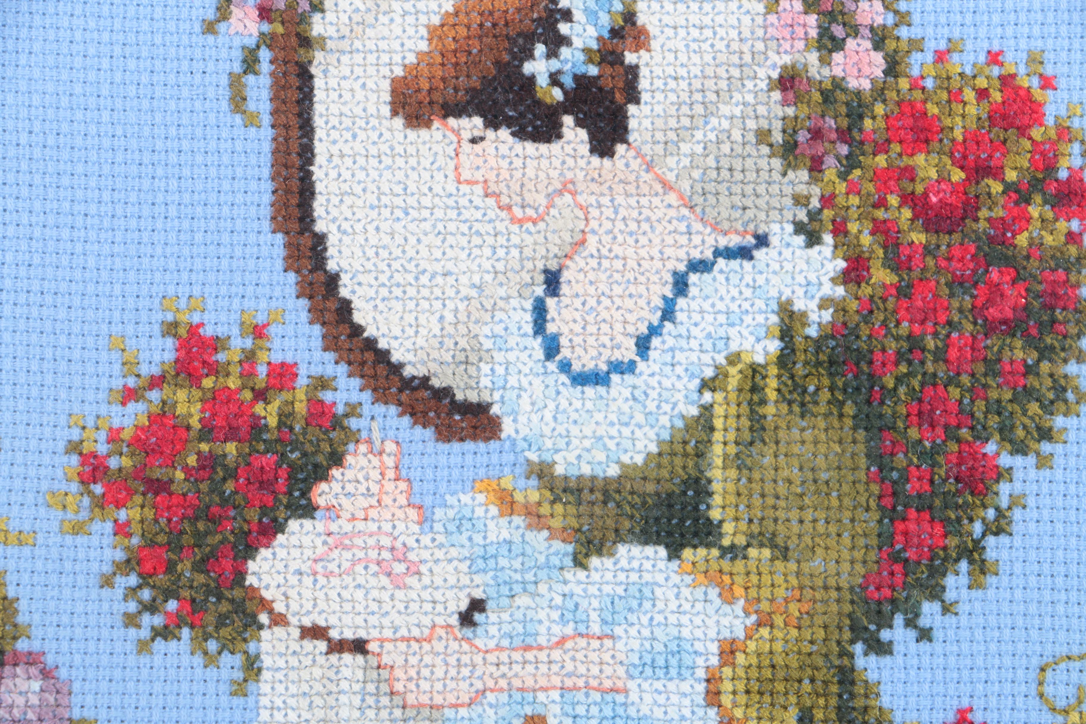 Cross-Stitch Embroidery of a Woman Surrounded by a Wreath
