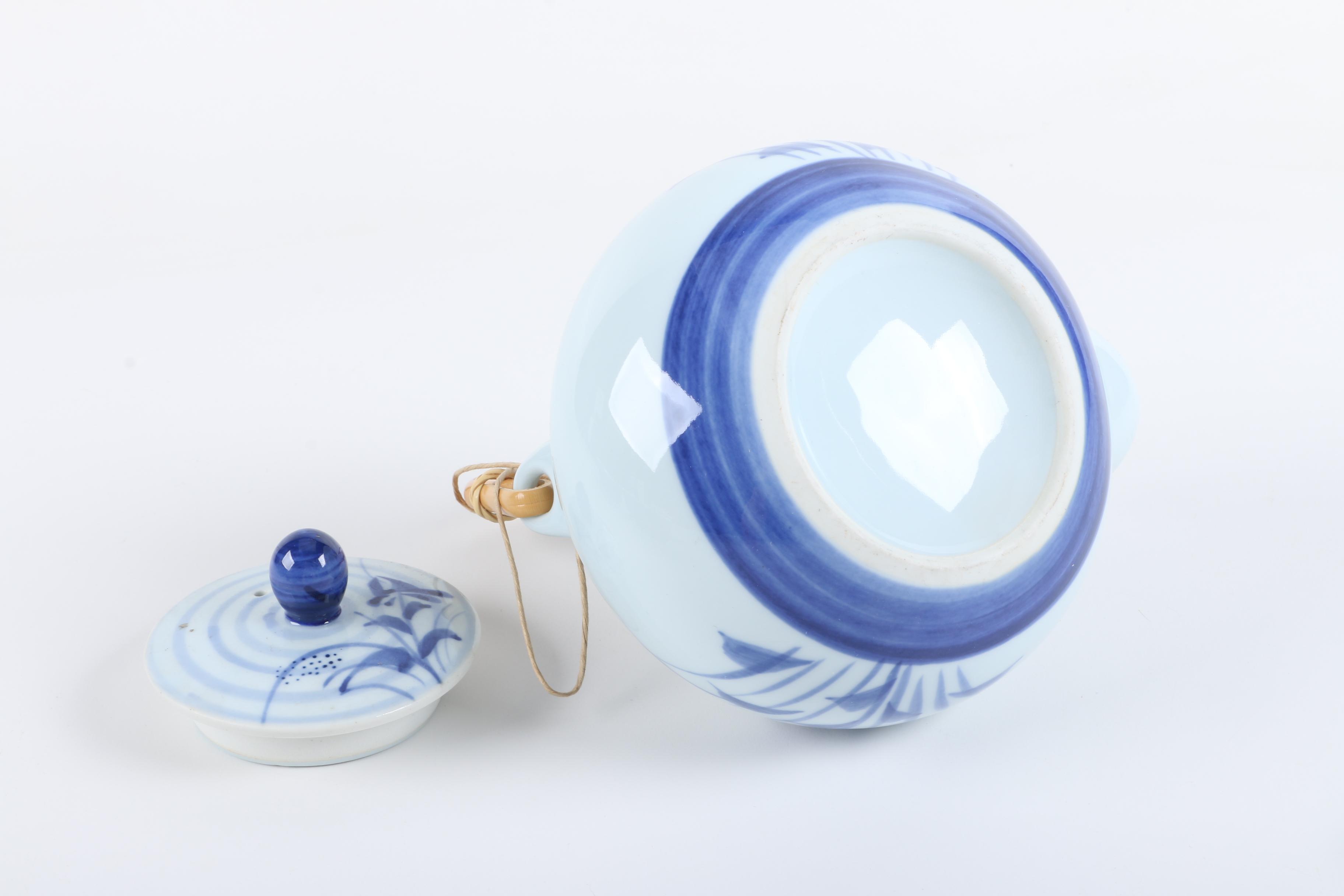 East Asian Porcelain Teapot and Tea Bowls