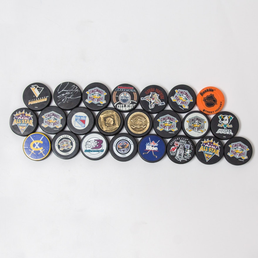 Grouping of Commemorative and NHL Hockey Pucks