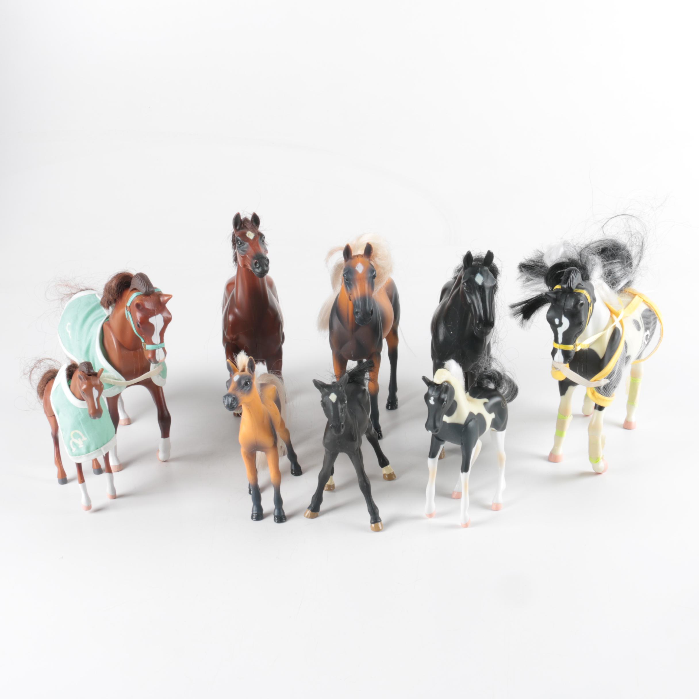 Nine Plastic Toy Horse Figures