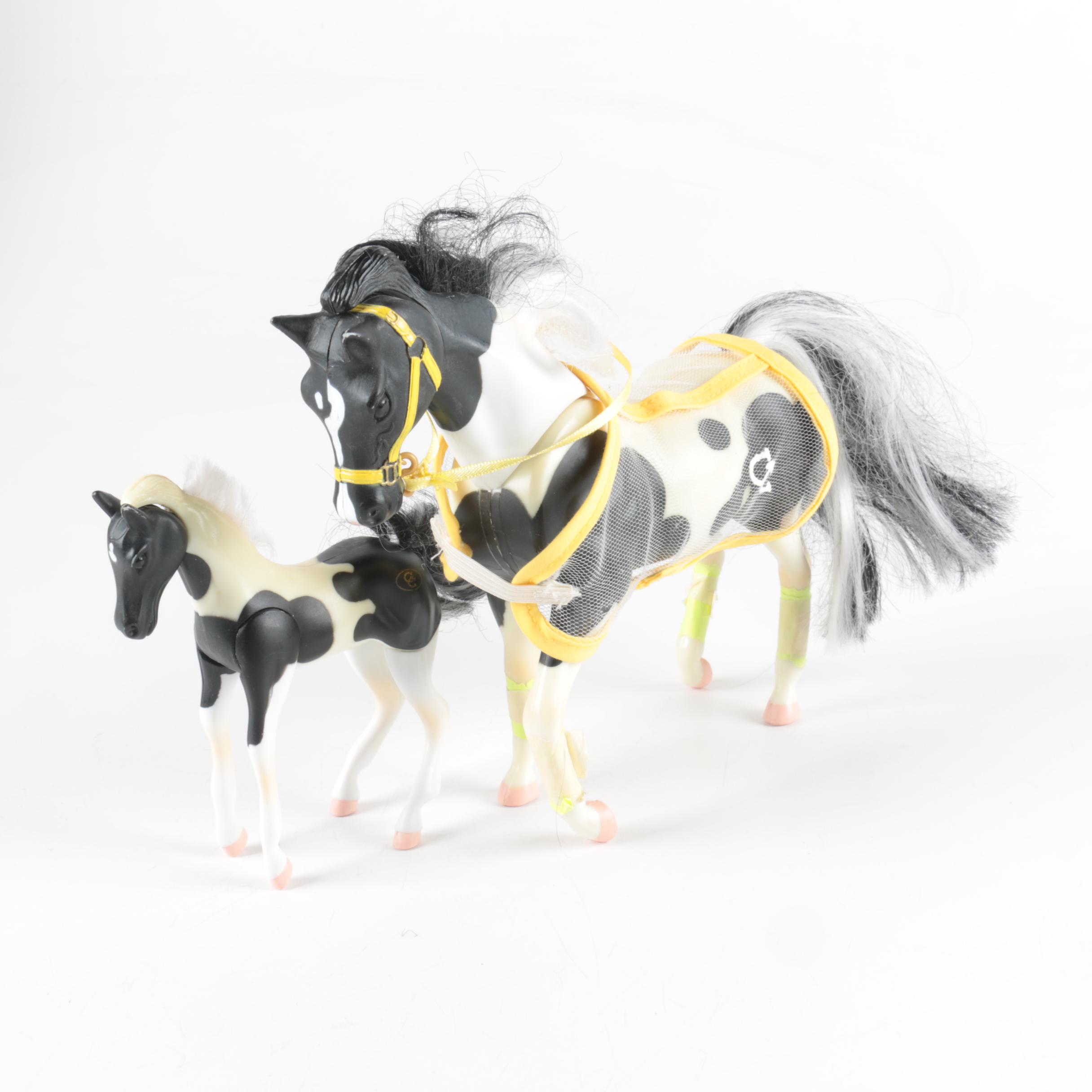 Nine Plastic Toy Horse Figures