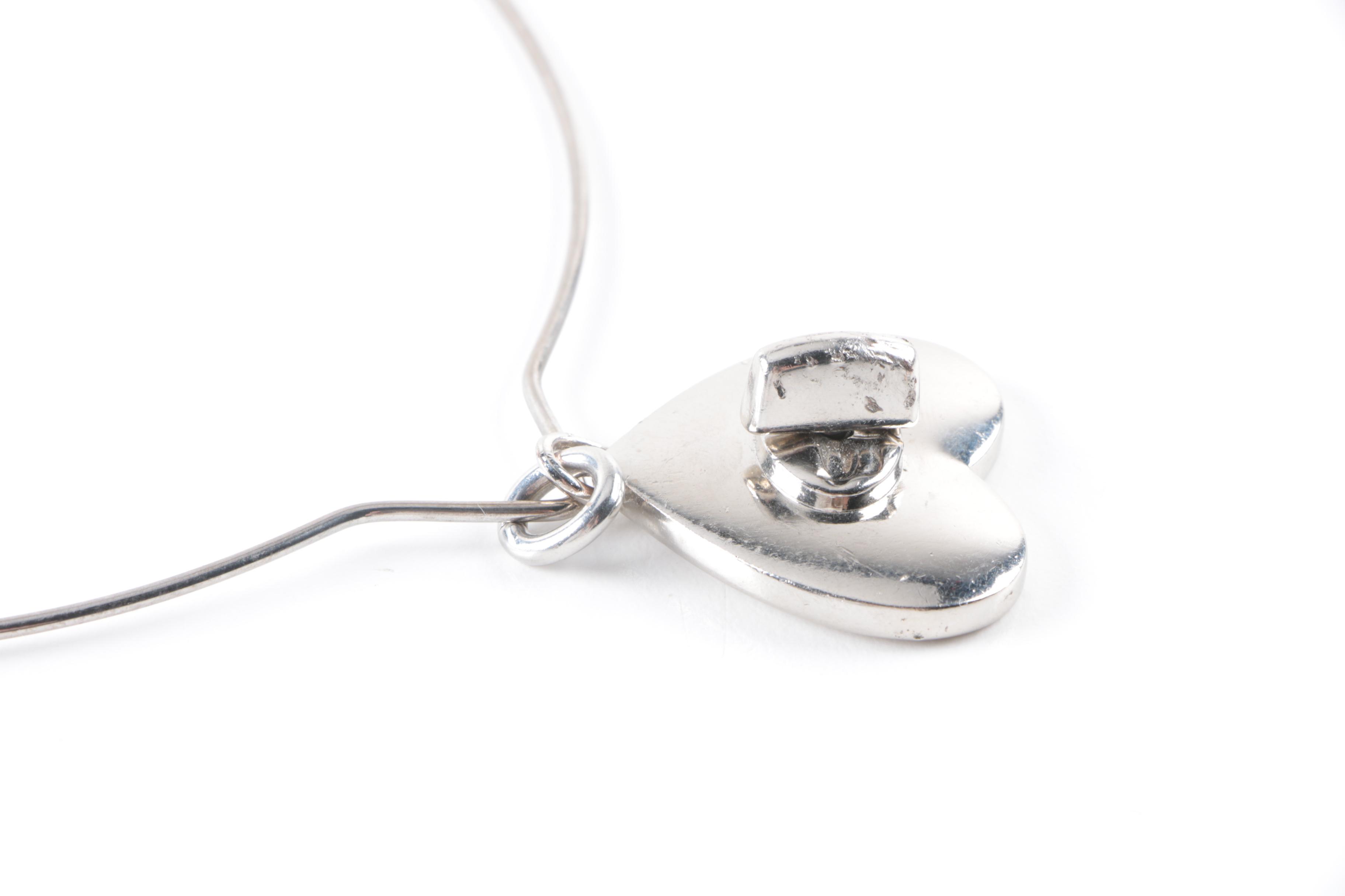 Collection of Costume Jewelry Featuring Coach Necklace and Swarovski Earrings