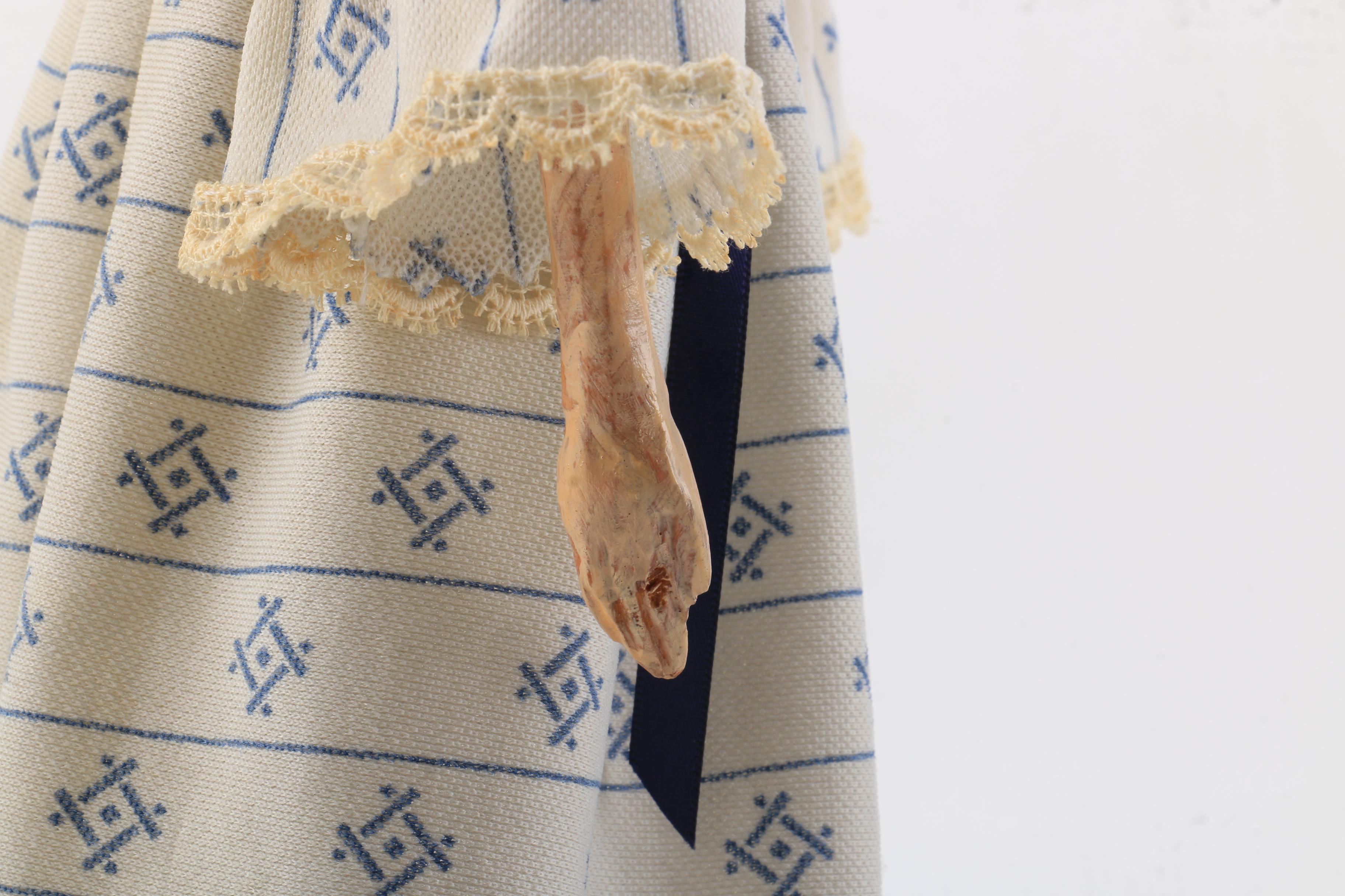 Carved Wood Doll Featuring a Detailed and Painted Face