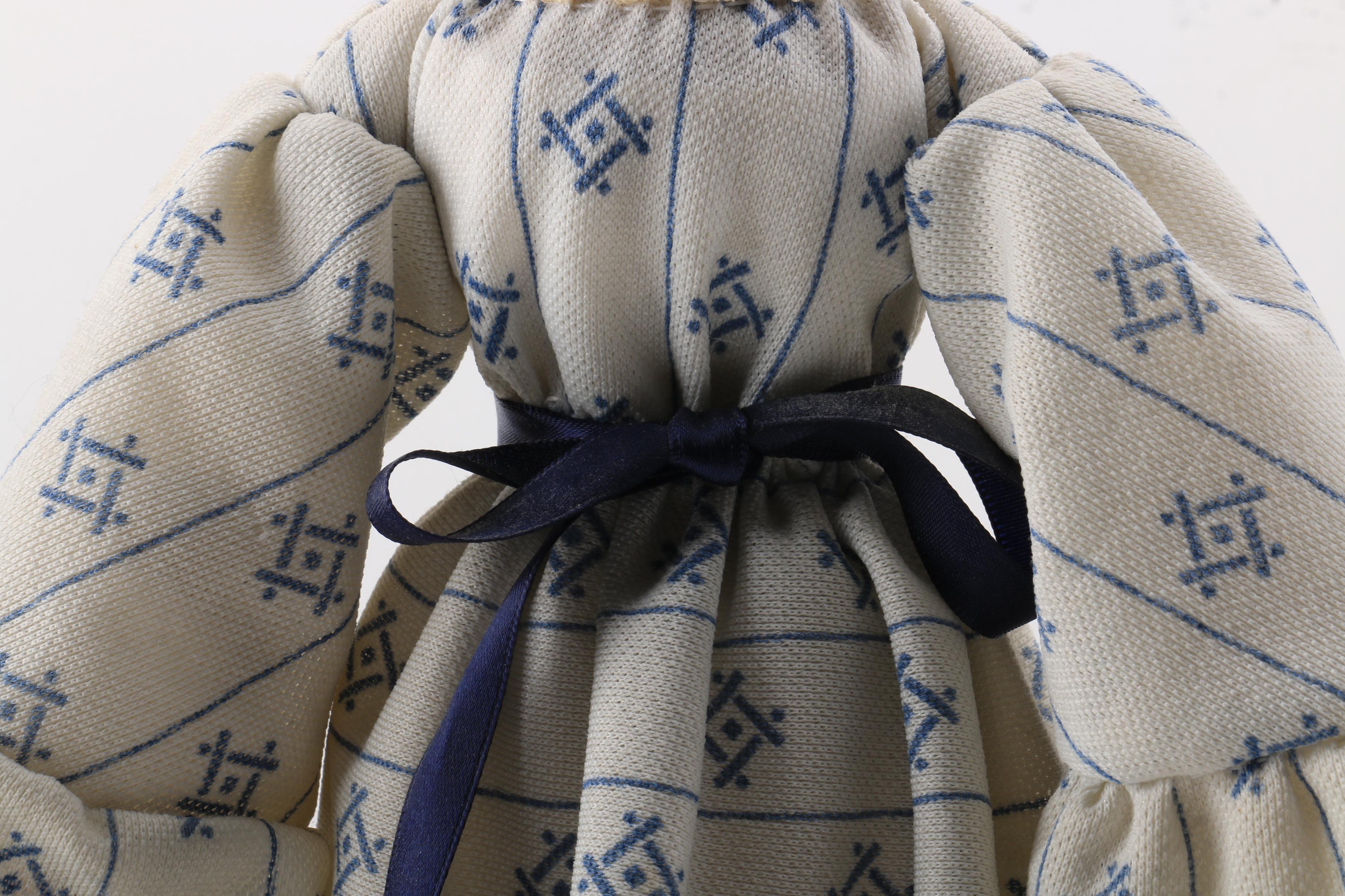 Carved Wood Doll Featuring a Detailed and Painted Face