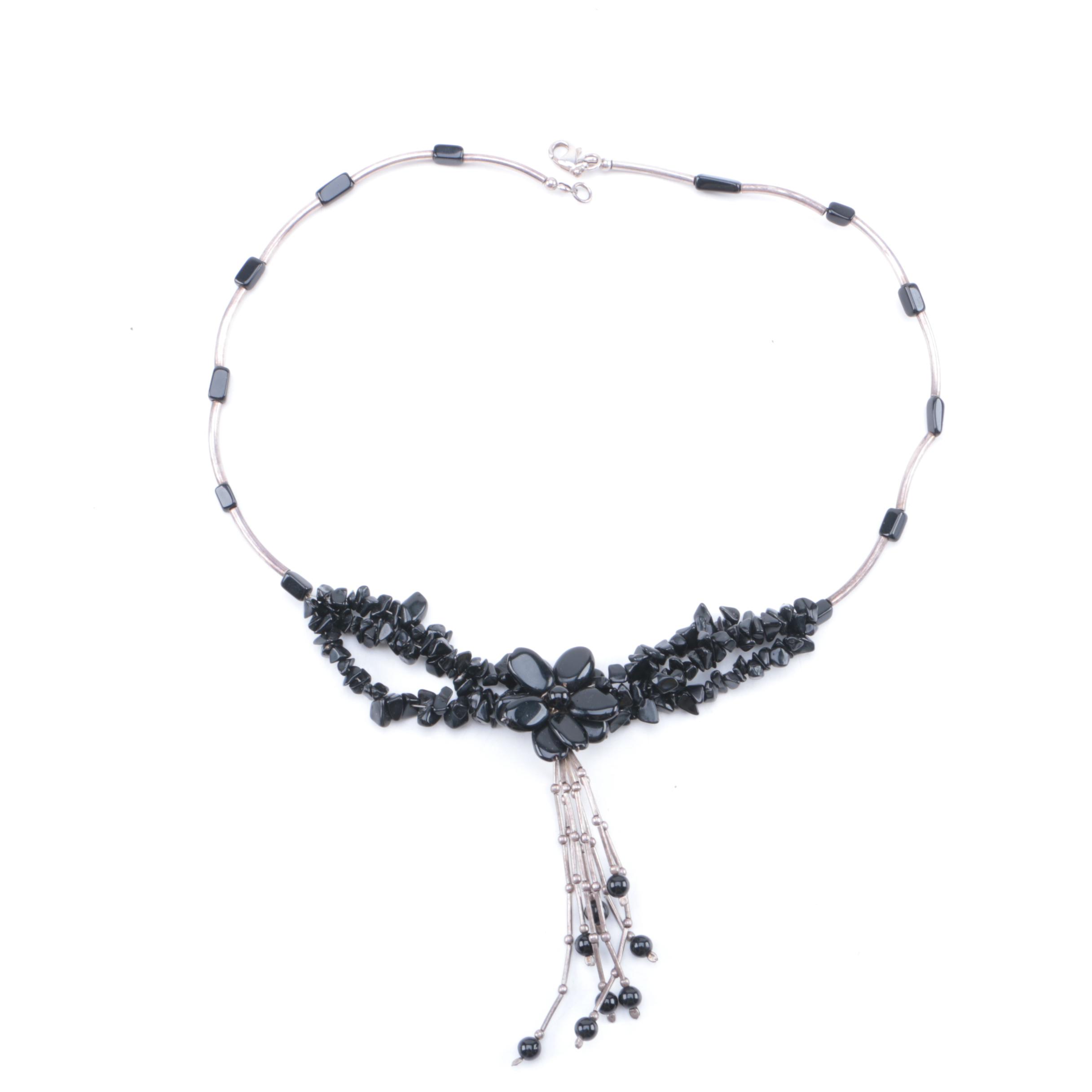 Assortment of Silver Tone Jewelry Including Obsidian, Glass, and Coral