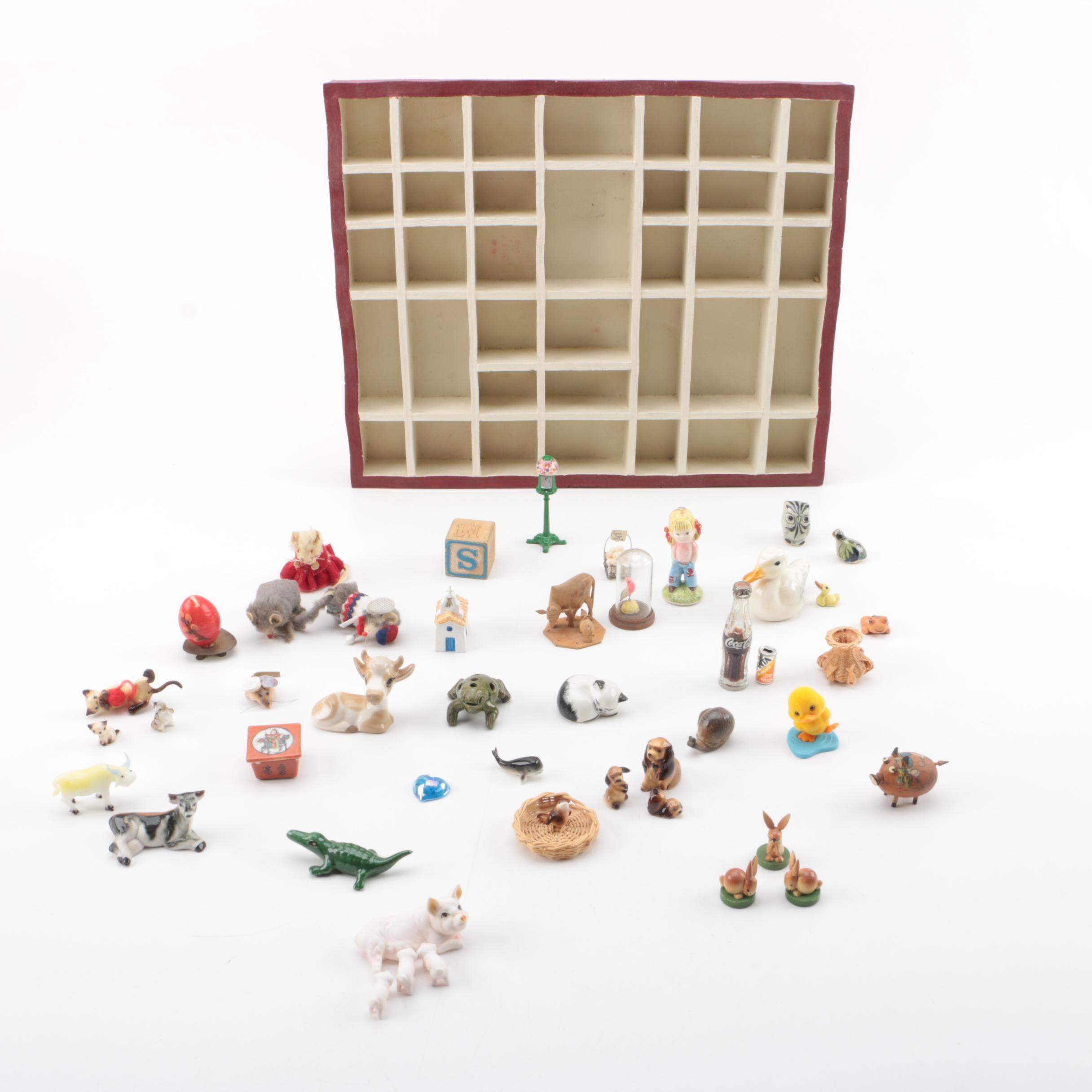 Vintage Figurines Featuring Goebel and a Display Shelf