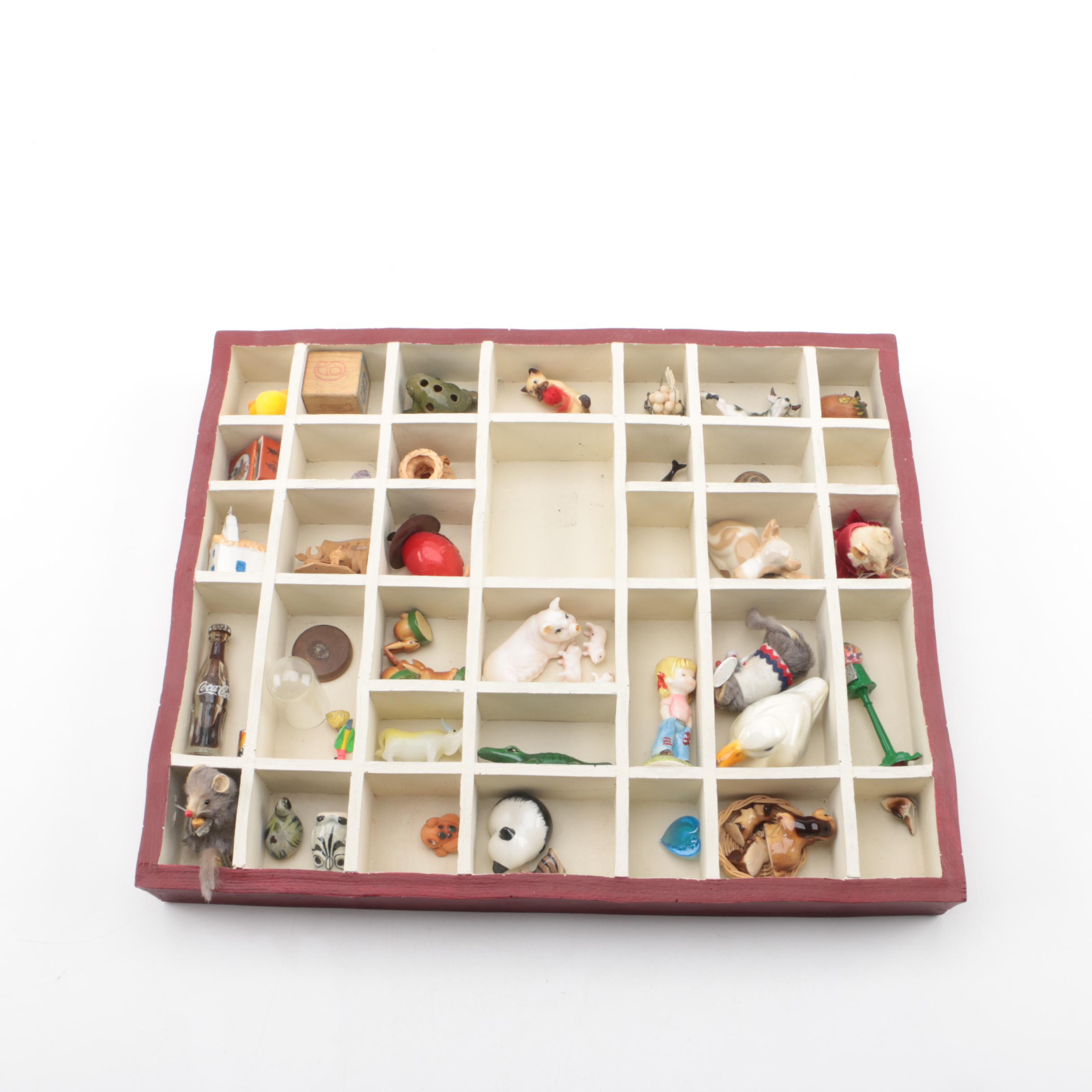 Vintage Figurines Featuring Goebel and a Display Shelf