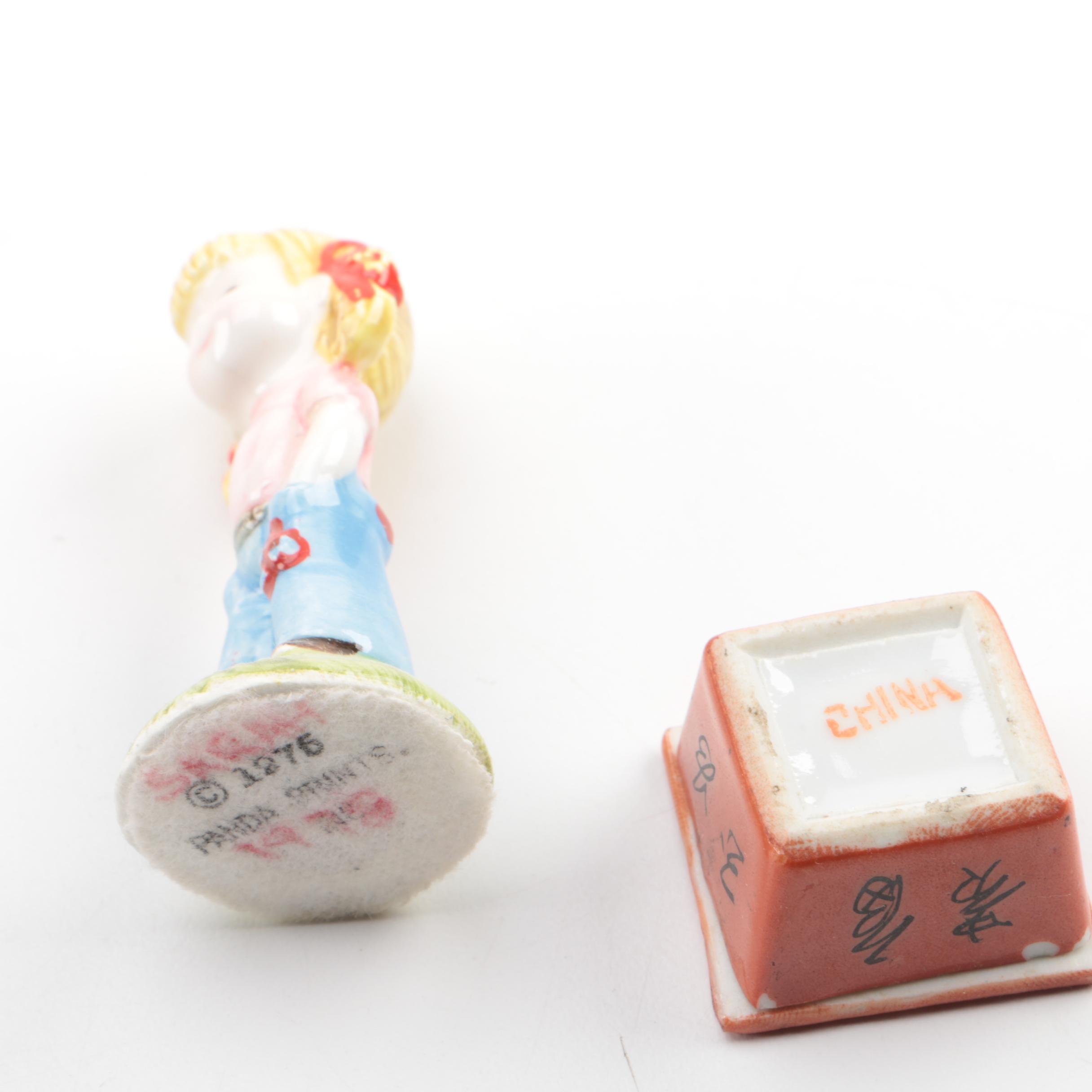 Vintage Figurines Featuring Goebel and a Display Shelf