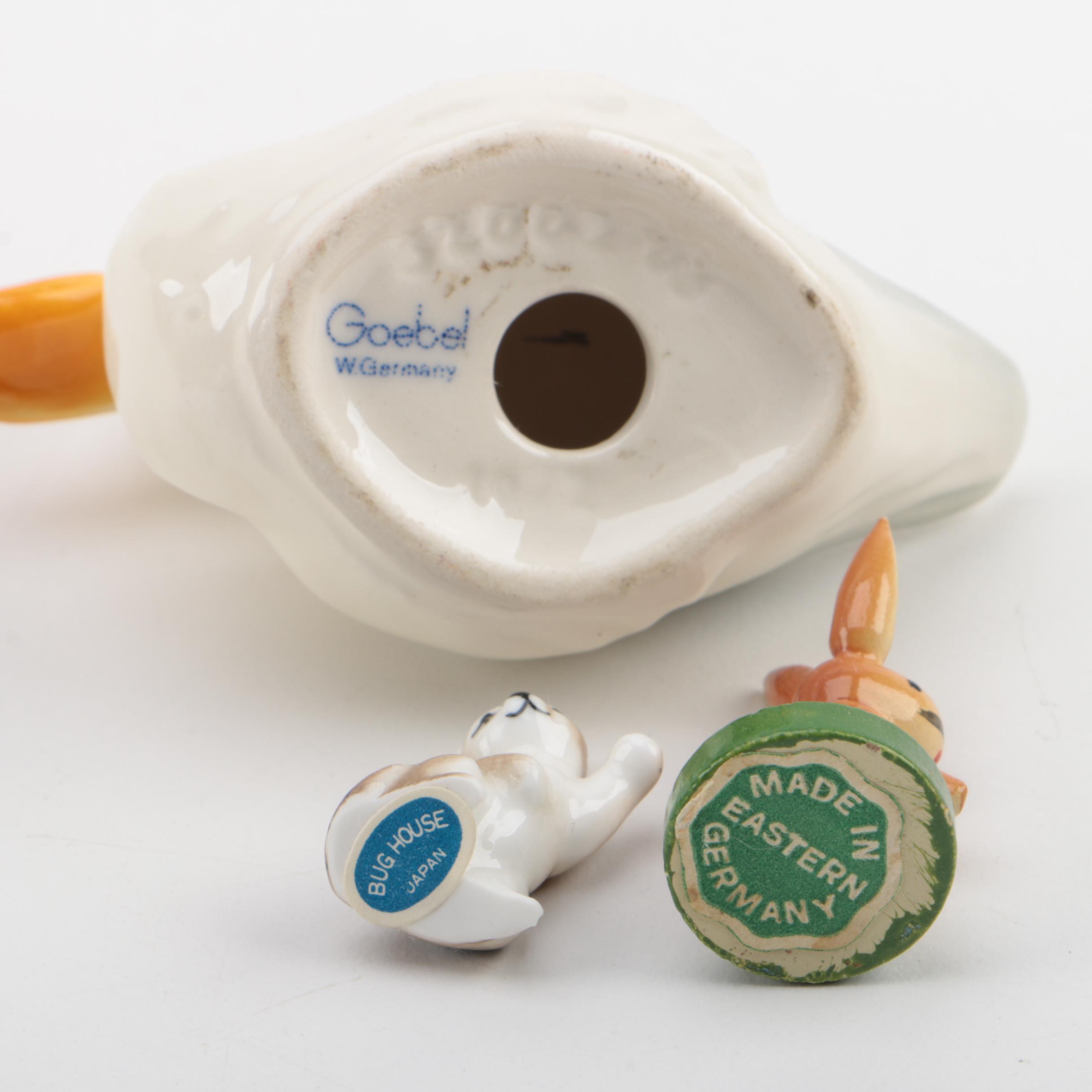 Vintage Figurines Featuring Goebel and a Display Shelf