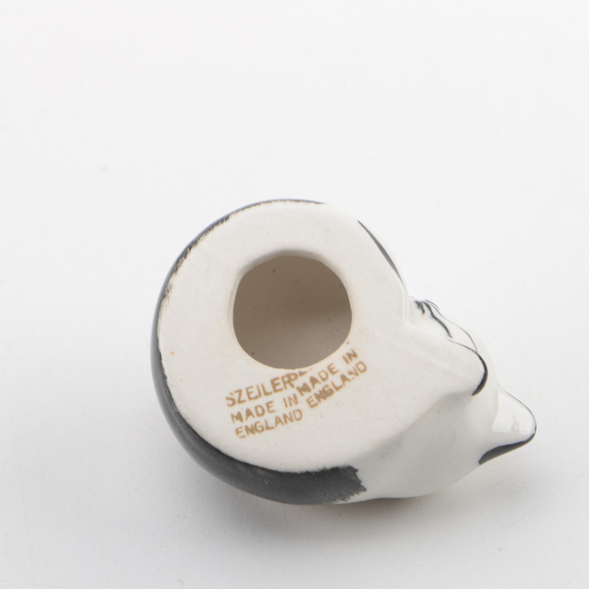 Vintage Figurines Featuring Goebel and a Display Shelf