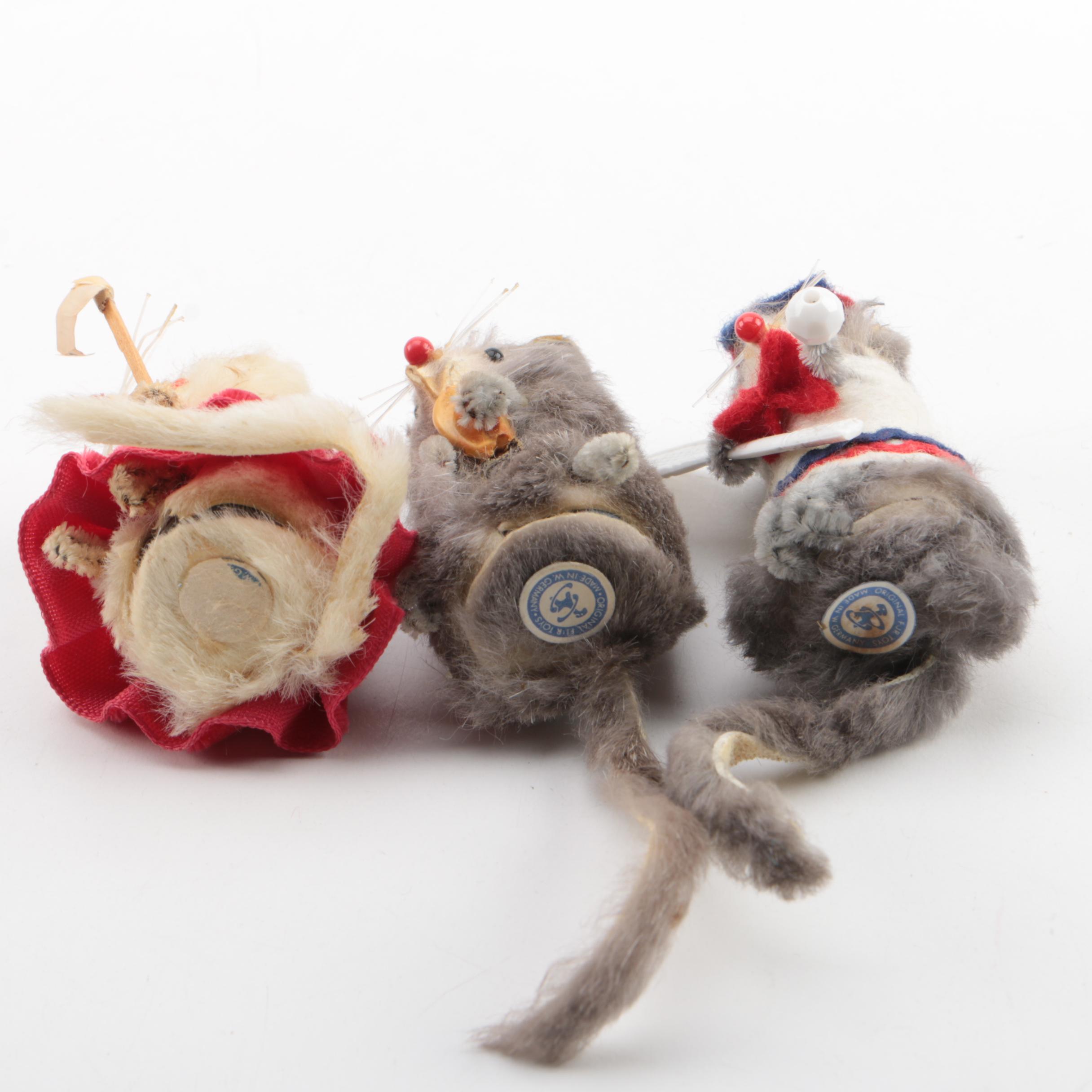 Vintage Figurines Featuring Goebel and a Display Shelf