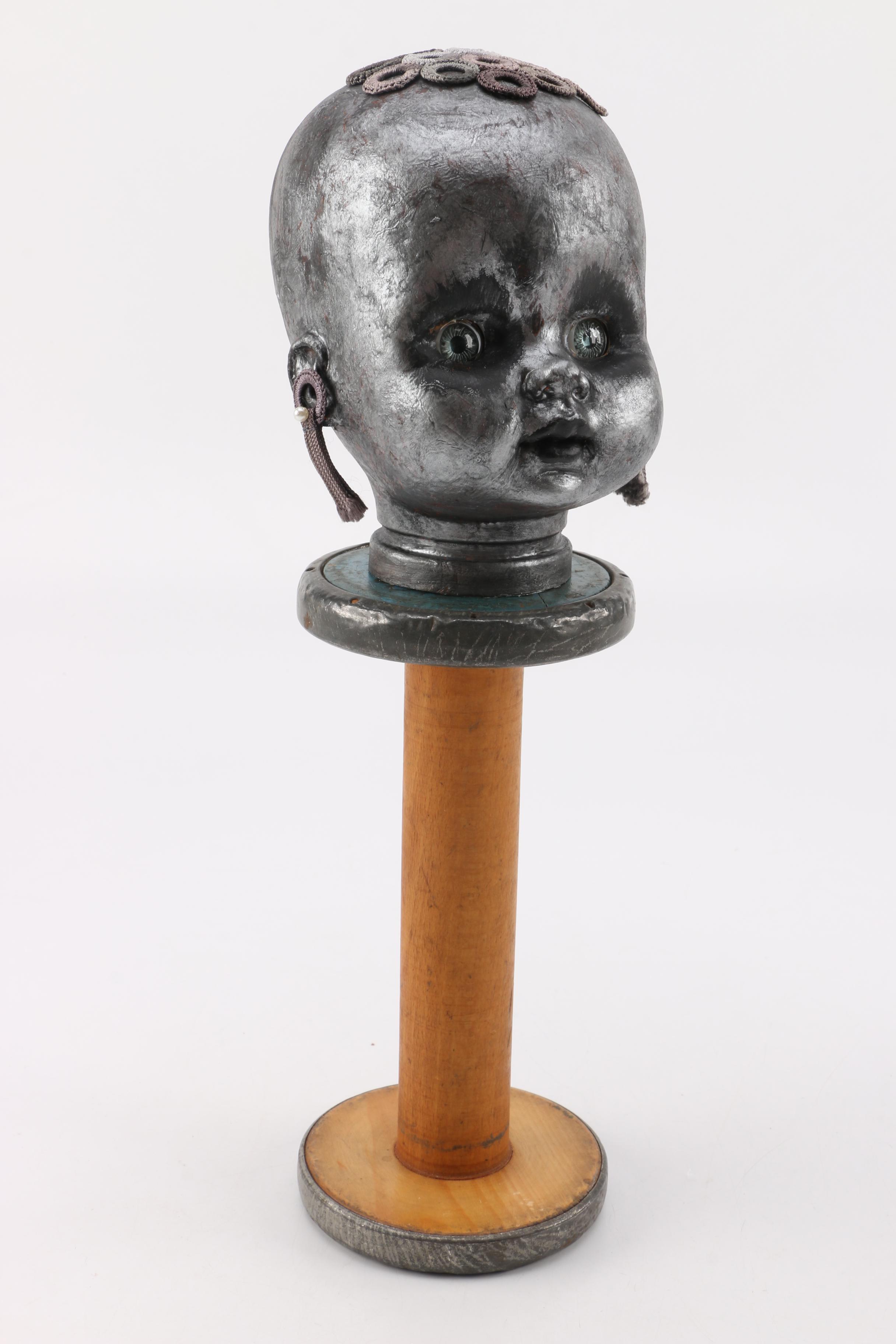 Doll Head Sculptures on Stands