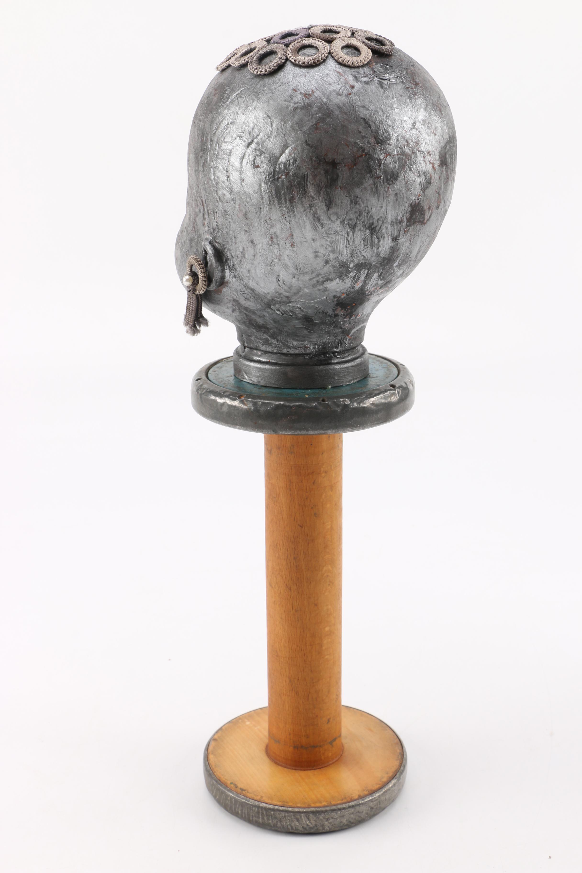 Doll Head Sculptures on Stands