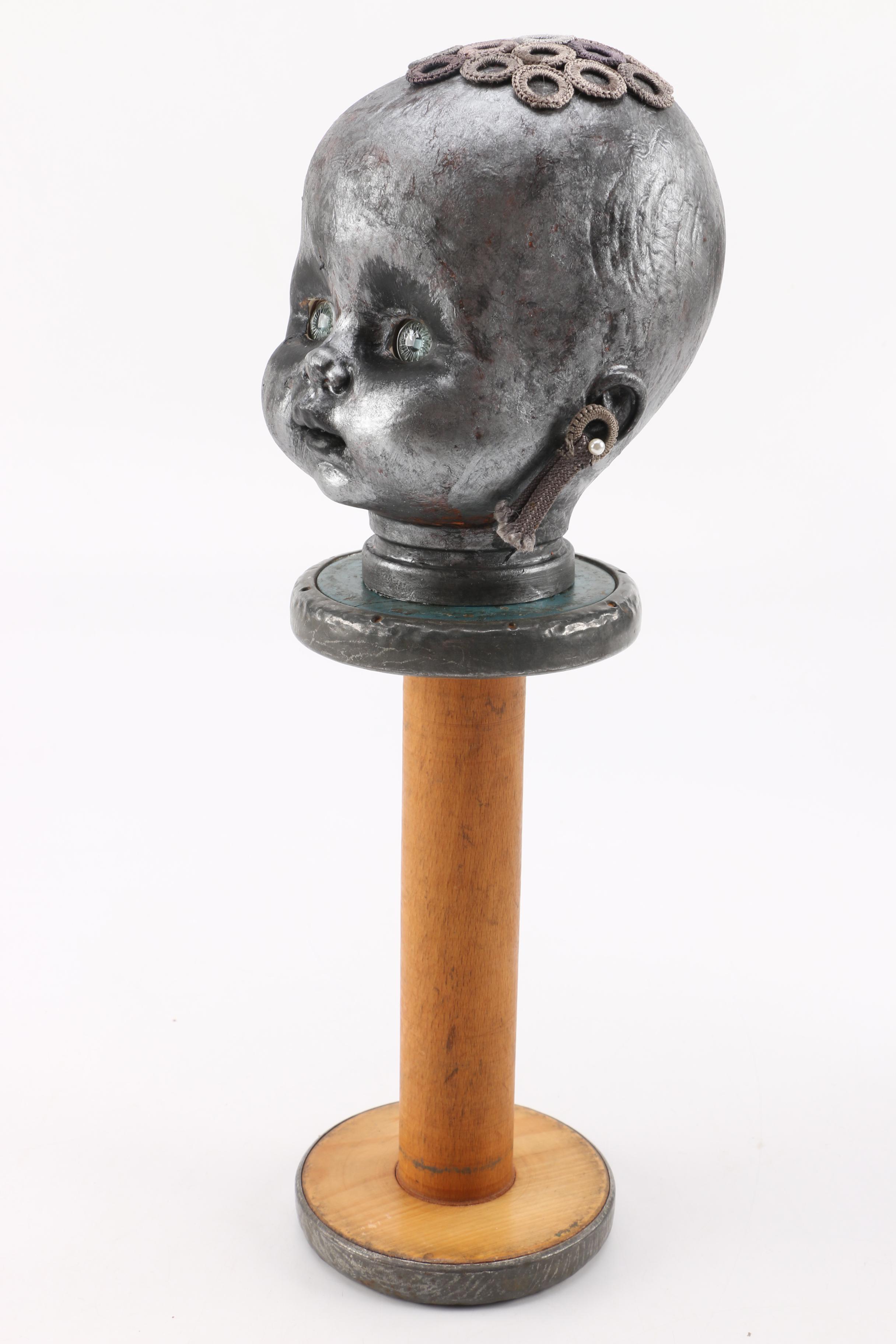 Doll Head Sculptures on Stands