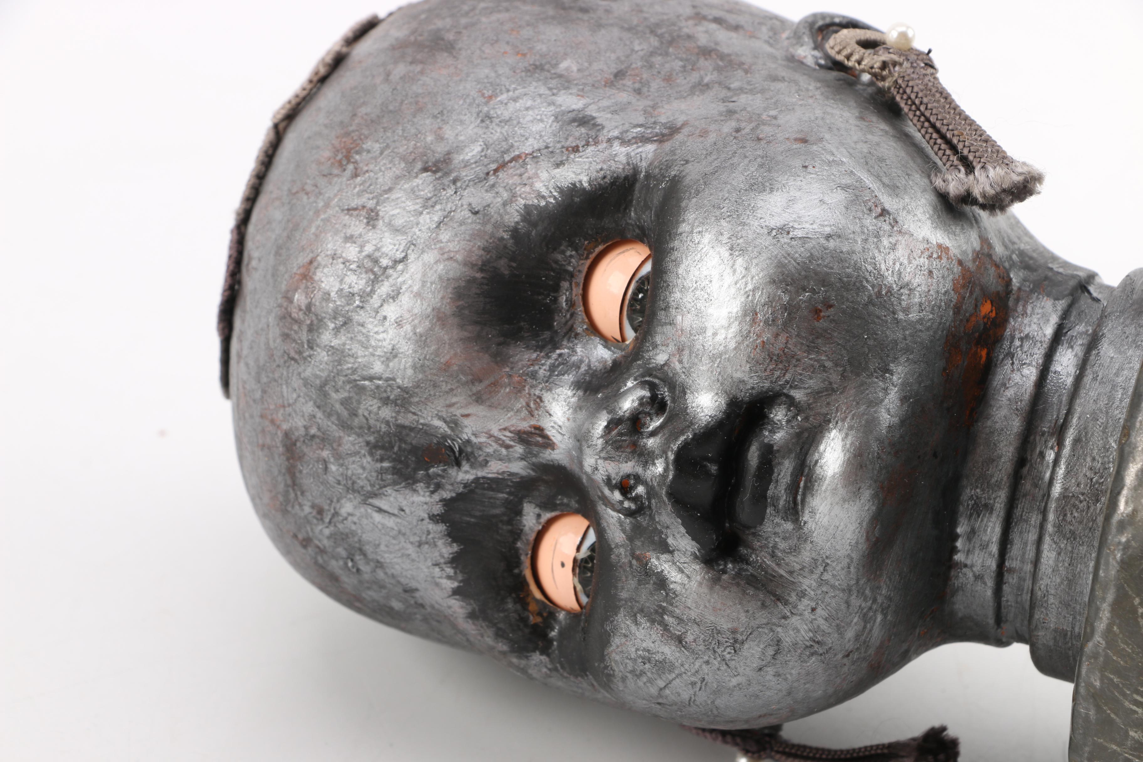 Doll Head Sculptures on Stands