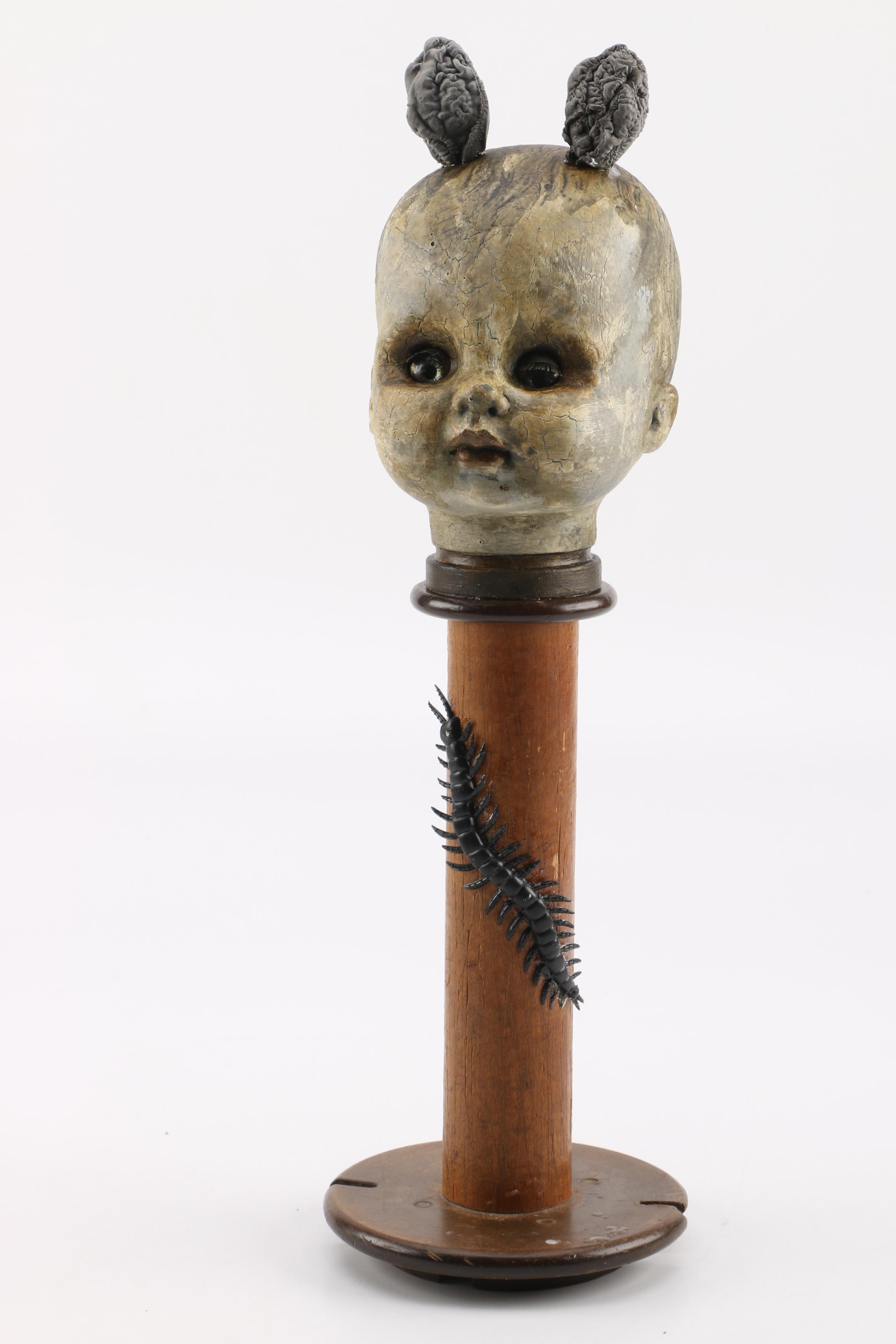 Doll Head Sculptures on Stands