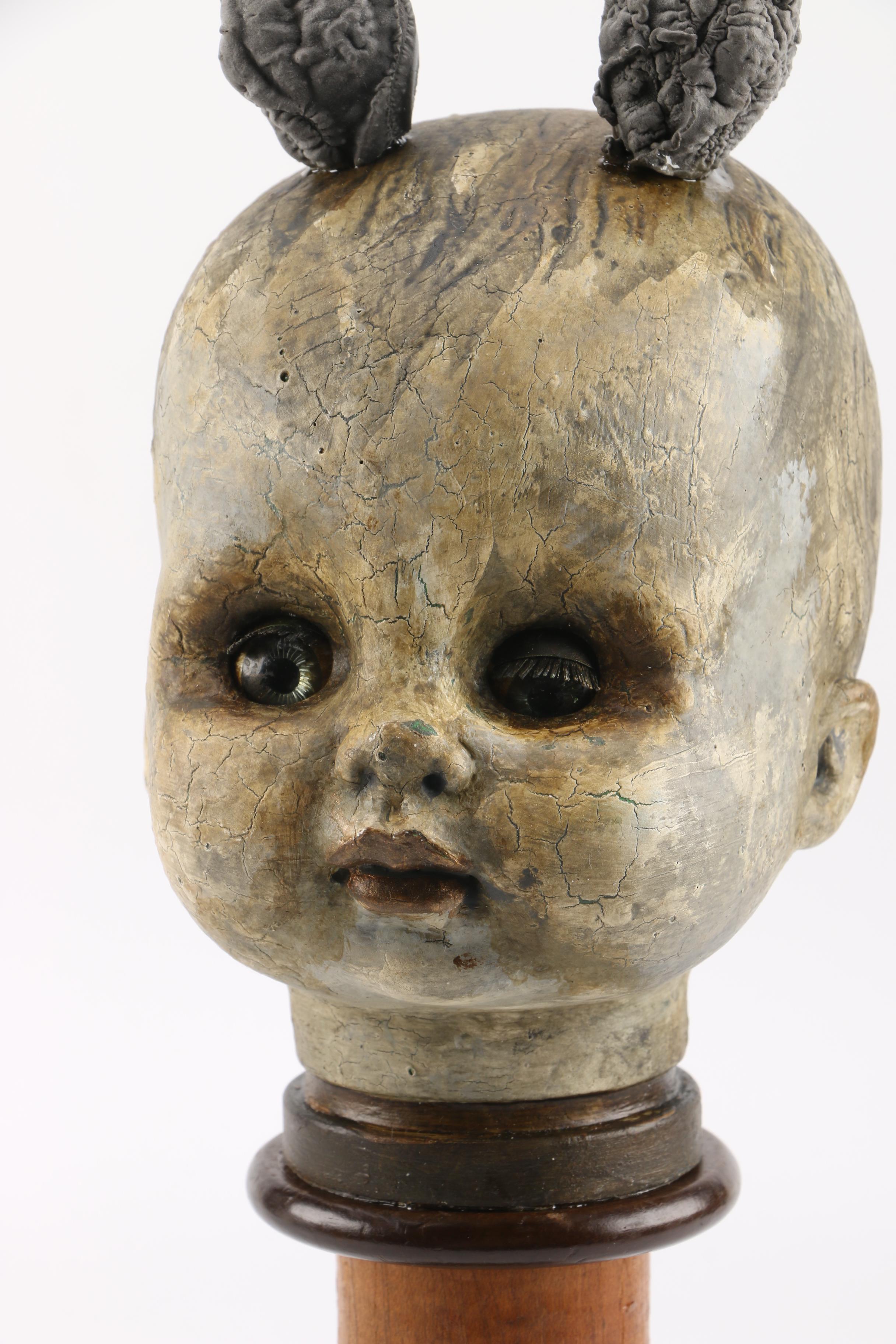 Doll Head Sculptures on Stands