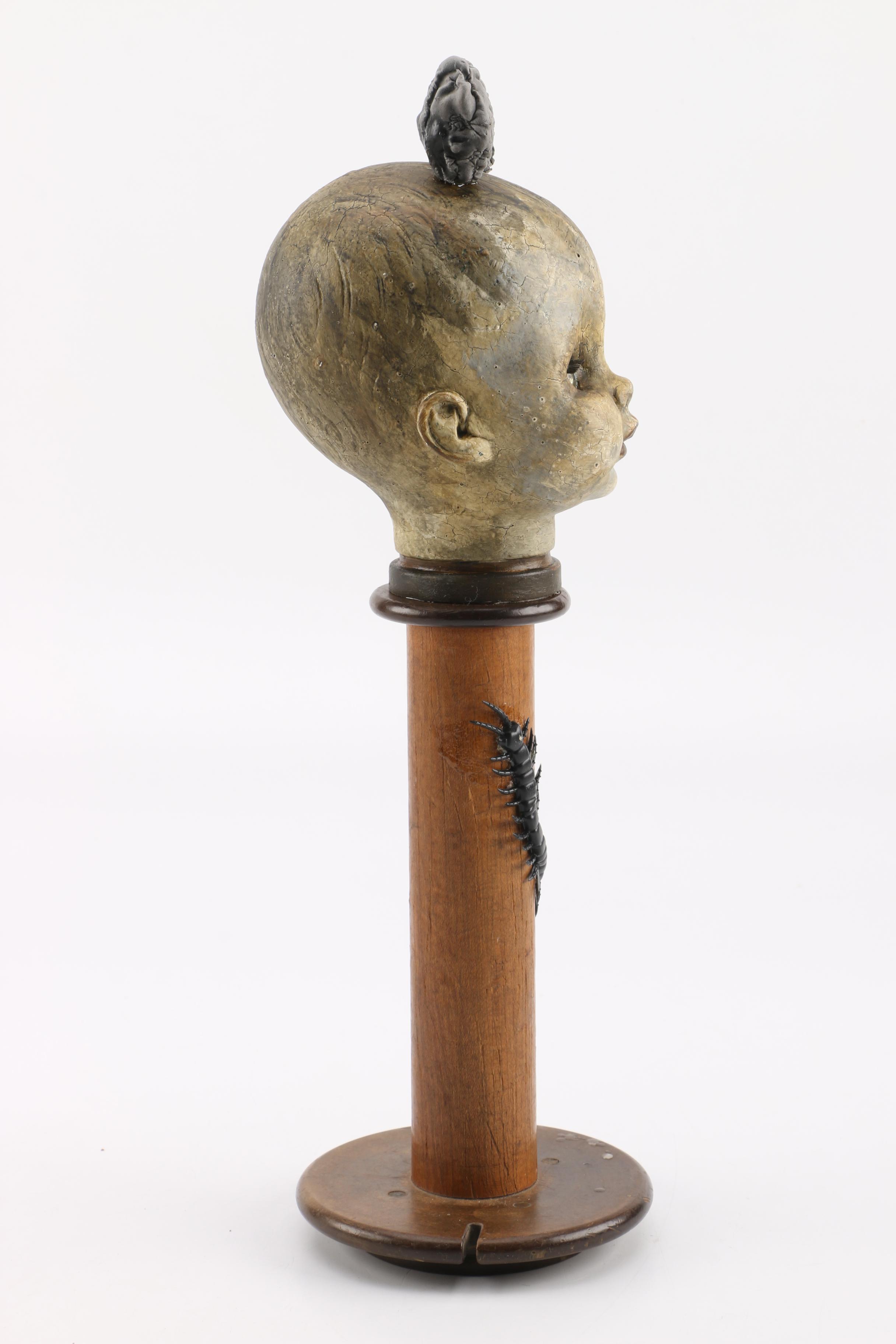 Doll Head Sculptures on Stands