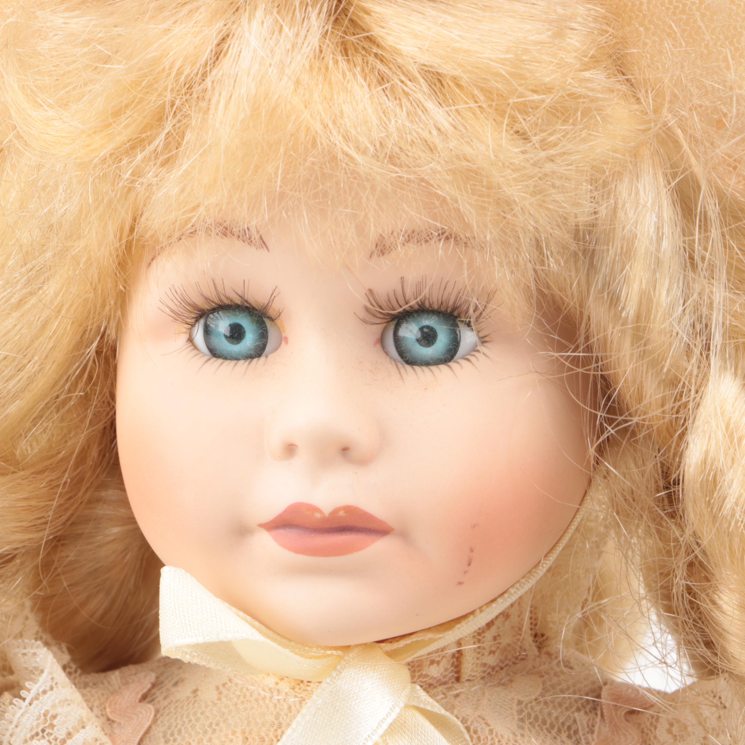 Vintage Porcelain Dolls with Blue Eyes and Blonde Curls