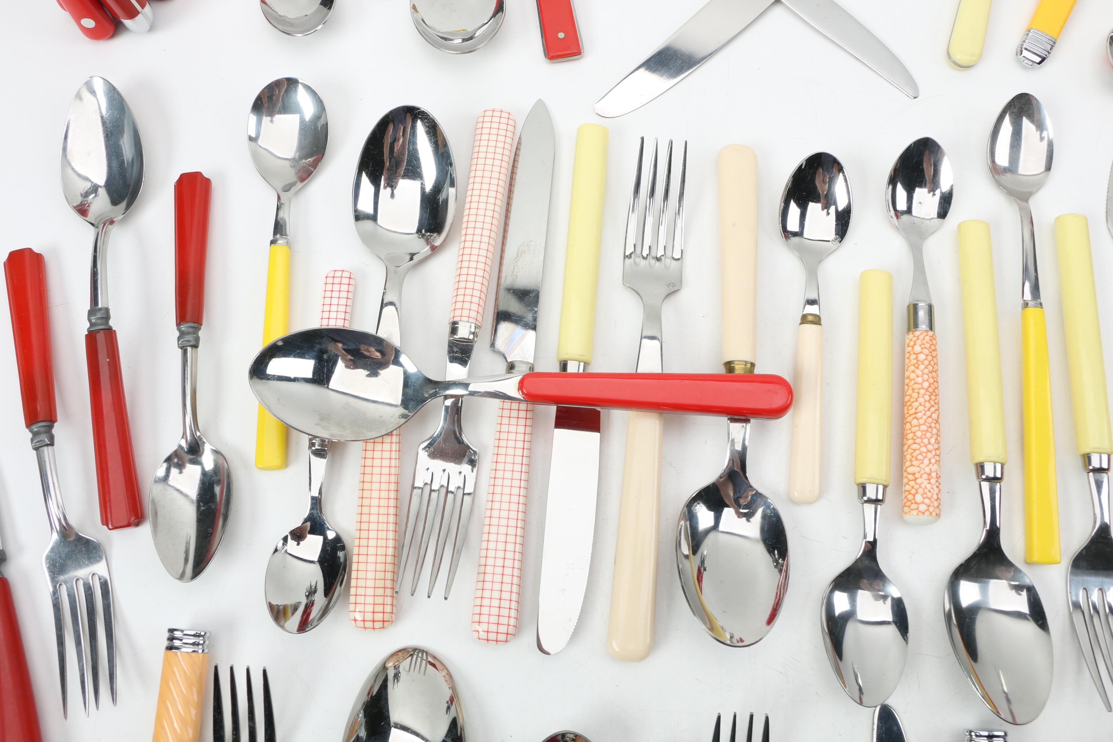 Collection of Stainless Flatware with Plastic Handles.