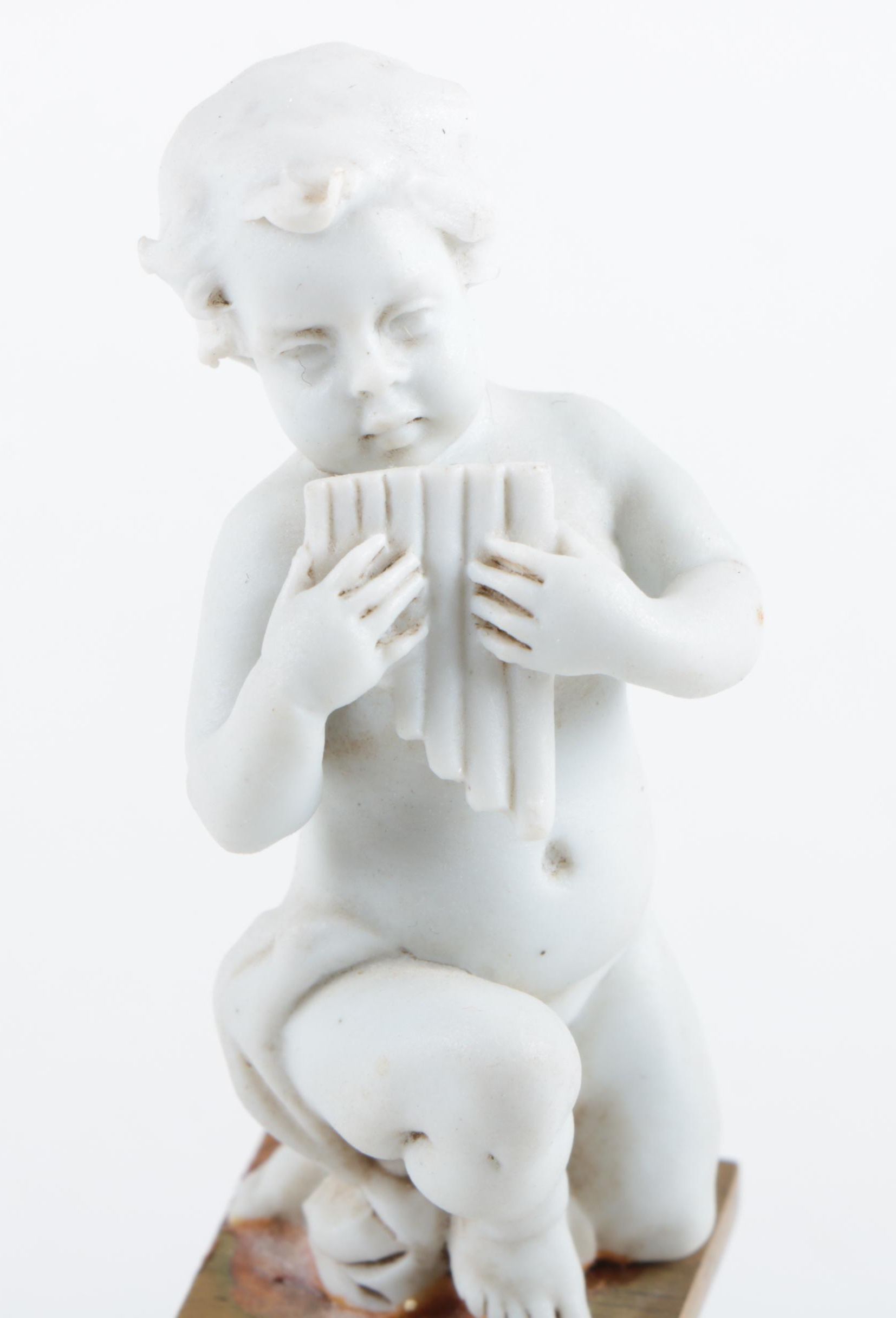 Nyphenburg Bisque Cherub Figurine Playing Pan Pipes on a Gold-Tone Metal Base