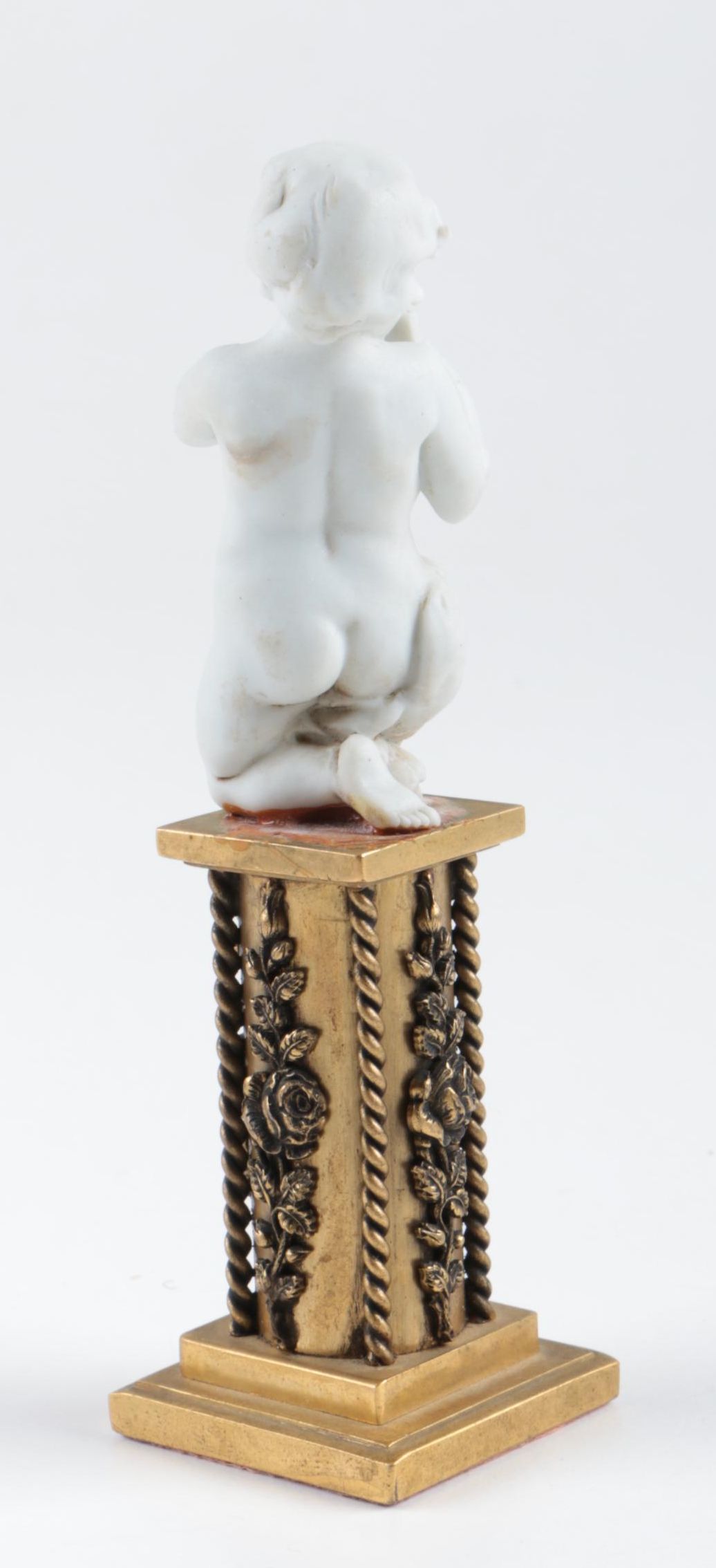 Nyphenburg Bisque Cherub Figurine Playing Pan Pipes on a Gold-Tone Metal Base