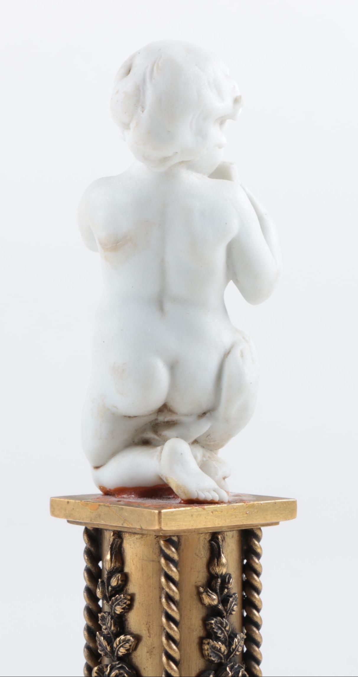 Nyphenburg Bisque Cherub Figurine Playing Pan Pipes on a Gold-Tone Metal Base