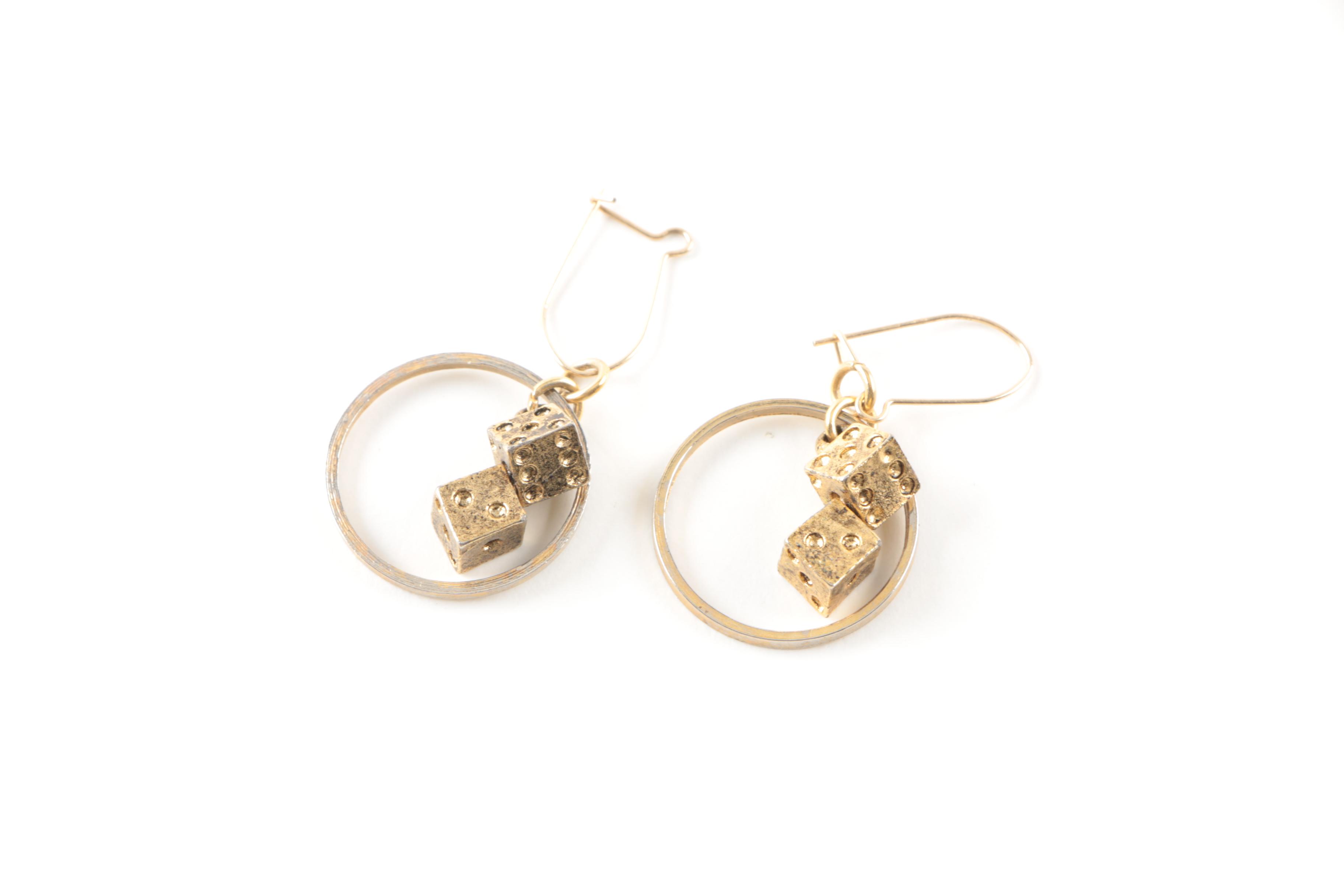 Gold Toned Costume Jewelry Featuring an Articulated Charm and Imitation Pearl