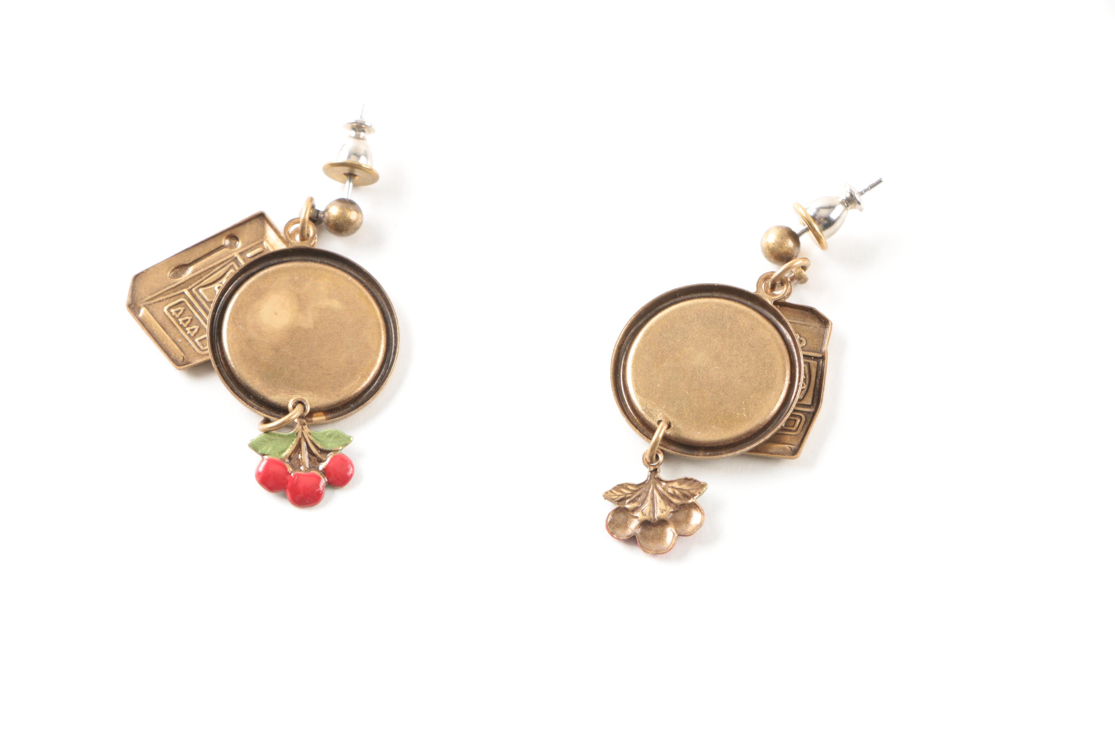 Gold Toned Costume Jewelry Featuring an Articulated Charm and Imitation Pearl