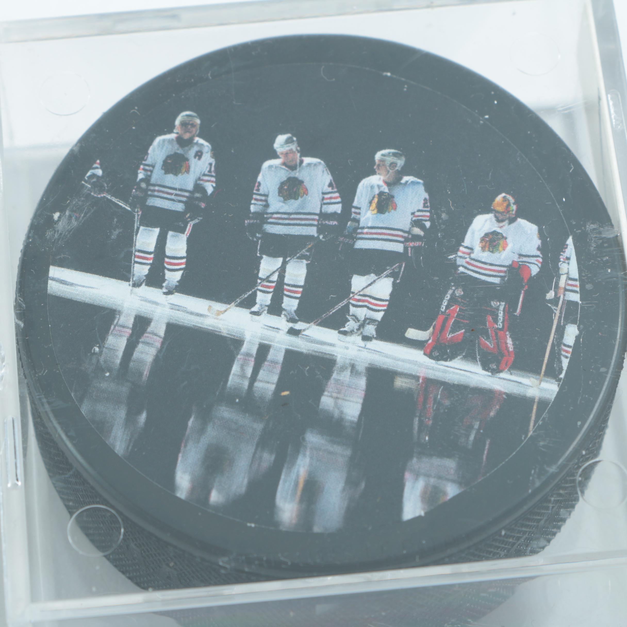 Autographed Chicago Blackhawks Hockey Pucks with 75th Anniversary Puck