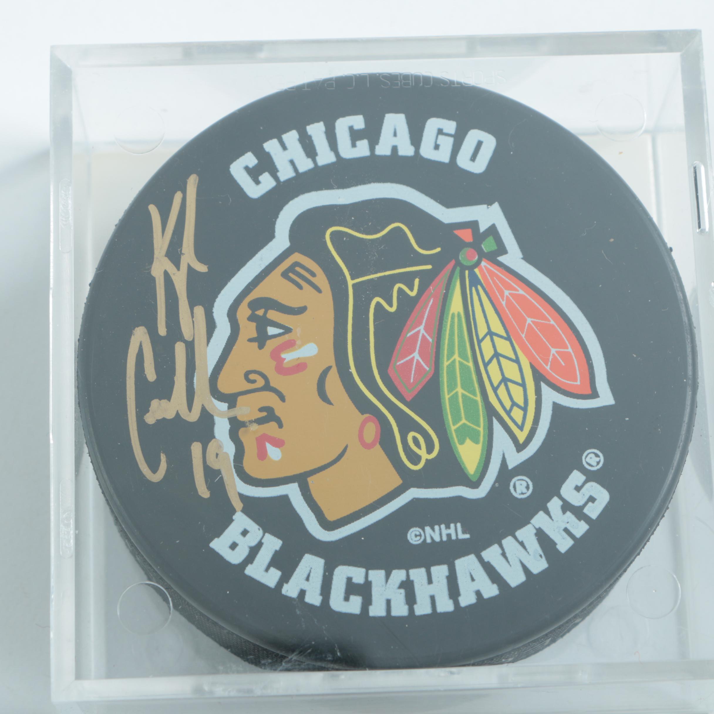 Autographed Chicago Blackhawks Hockey Pucks with 75th Anniversary Puck