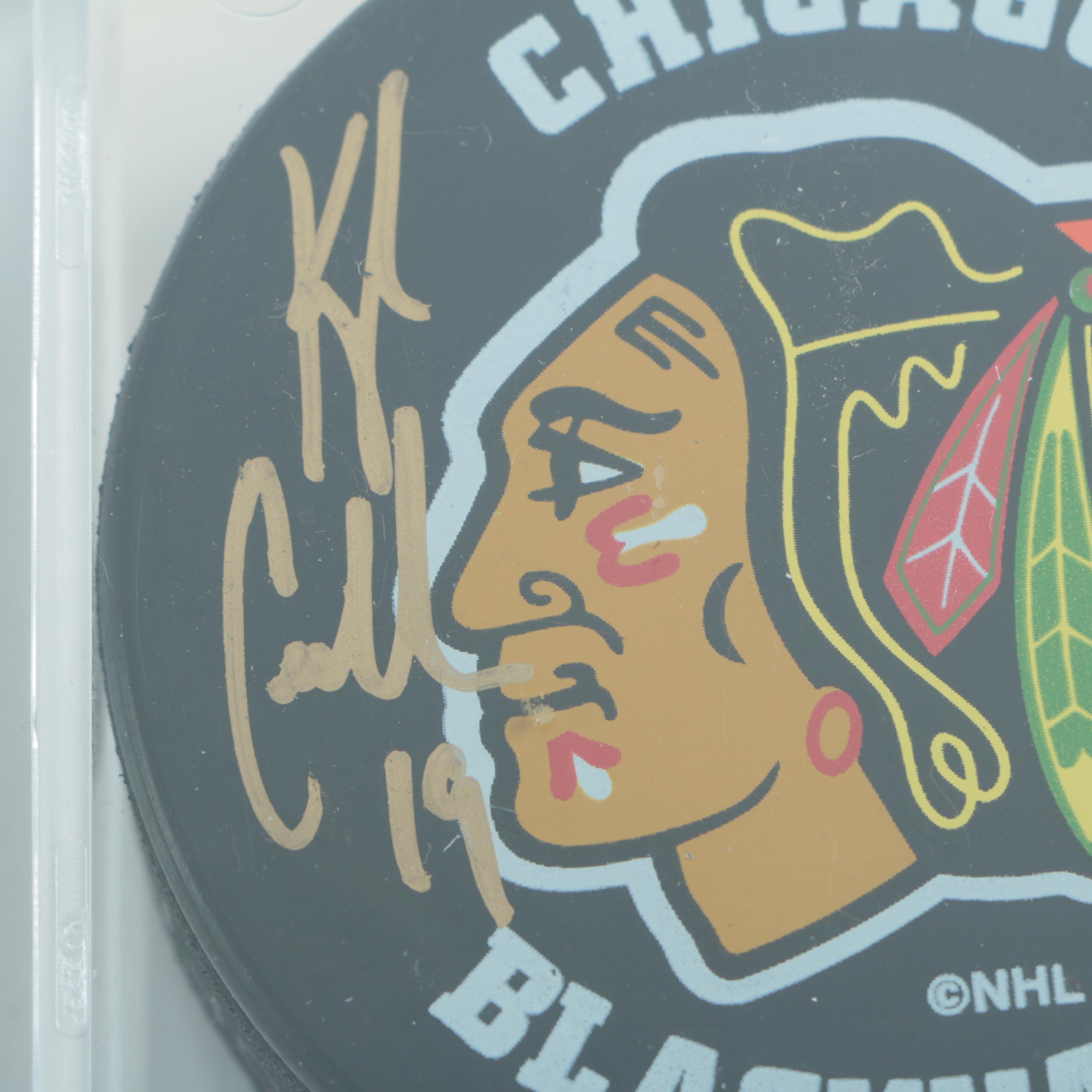 Autographed Chicago Blackhawks Hockey Pucks with 75th Anniversary Puck