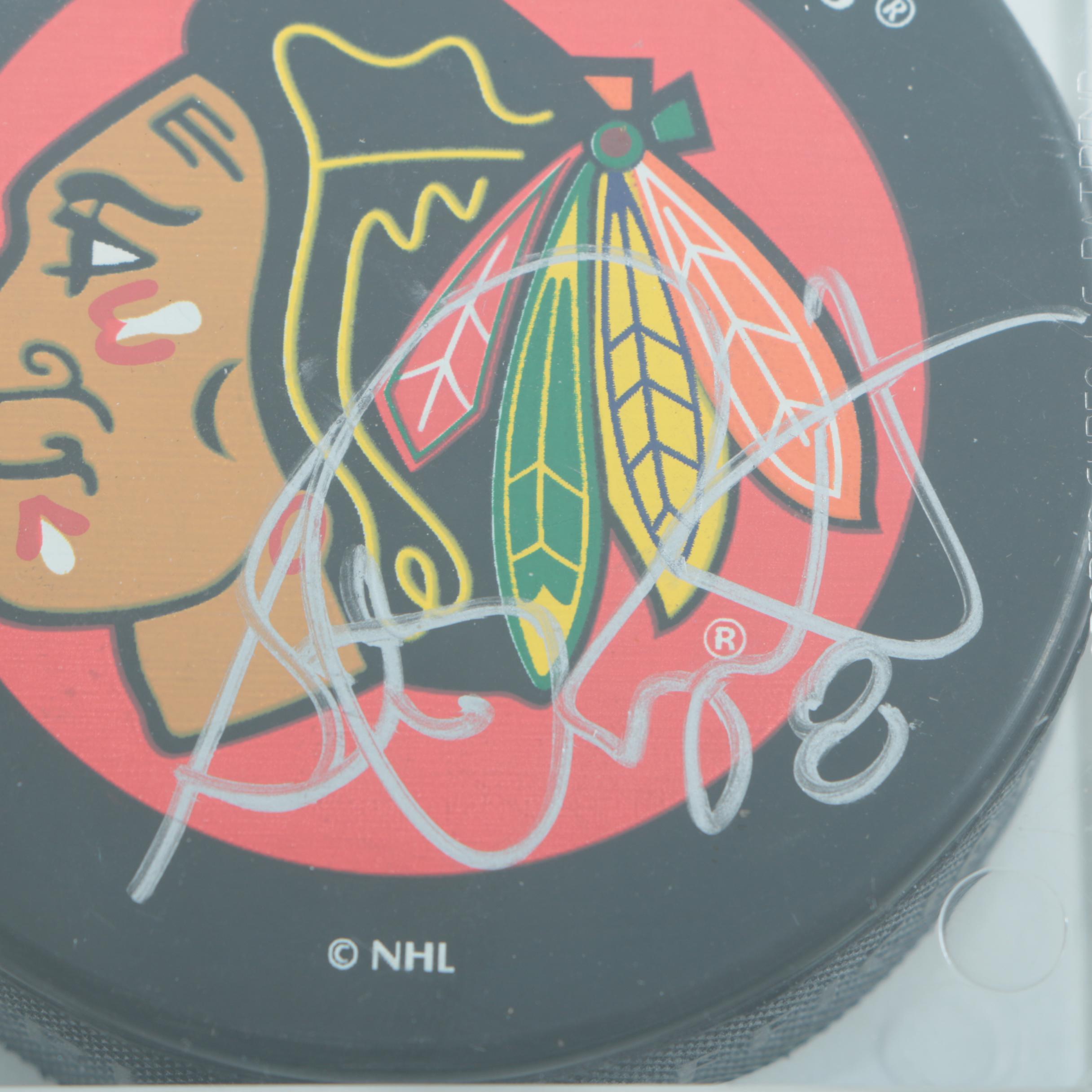 Autographed Chicago Blackhawks Hockey Pucks with 75th Anniversary Puck