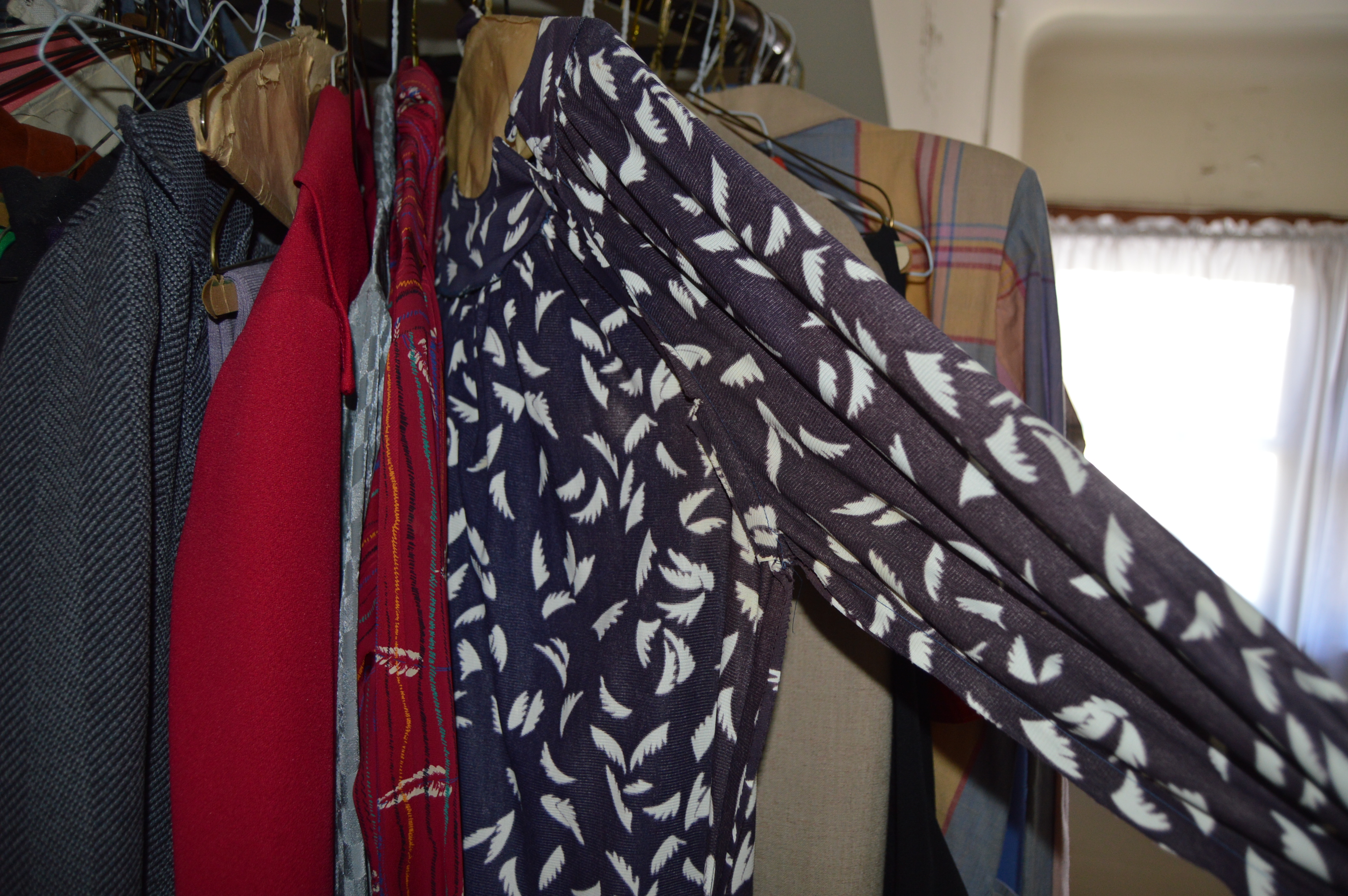 Vintage Iron Revolving Clothing Rack with Vintage Clothes Collection