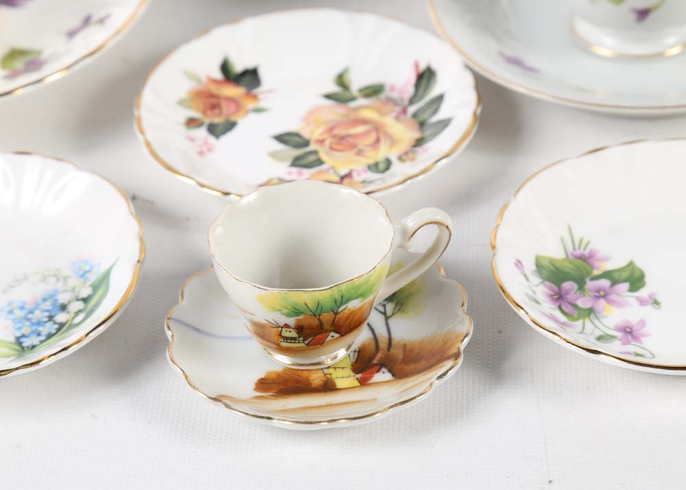 Assortment of Tea Cups, Saucers, and Spoon Rest