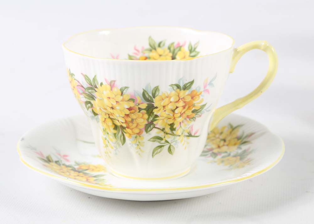 Assortment of Tea Cups, Saucers, and Spoon Rest