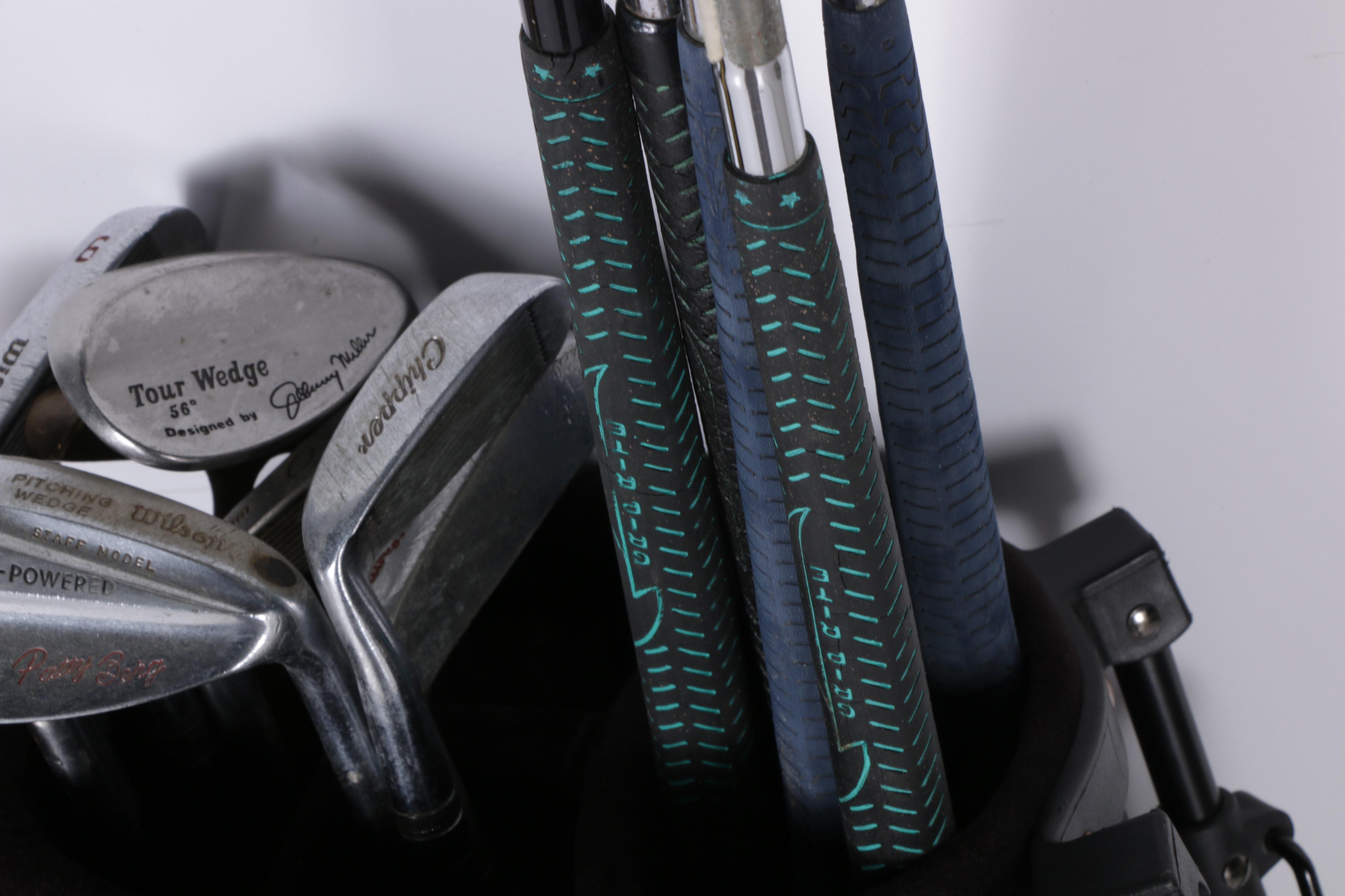 Various Golf Clubs with a Pair of Cases