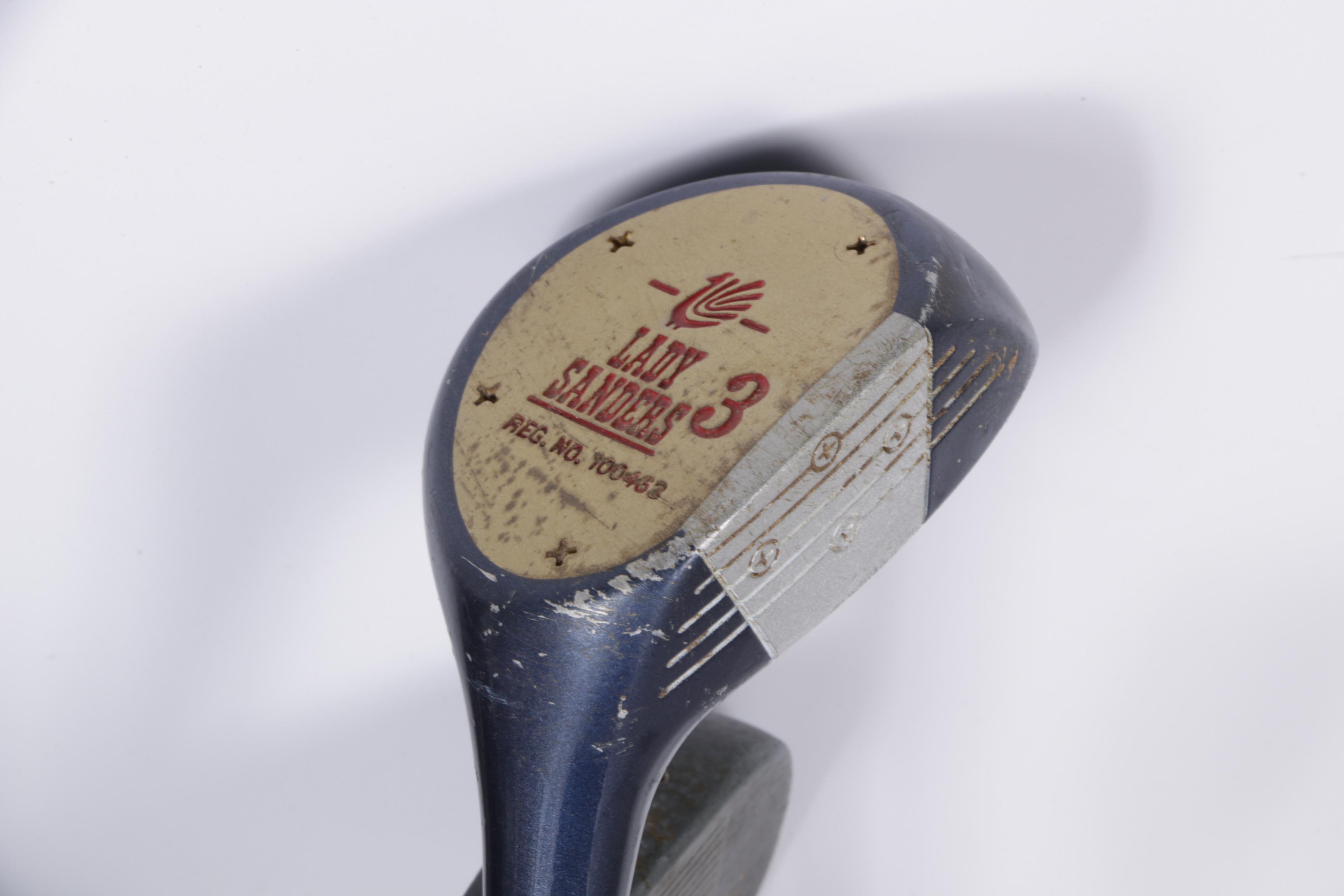 Various Golf Clubs with a Pair of Cases