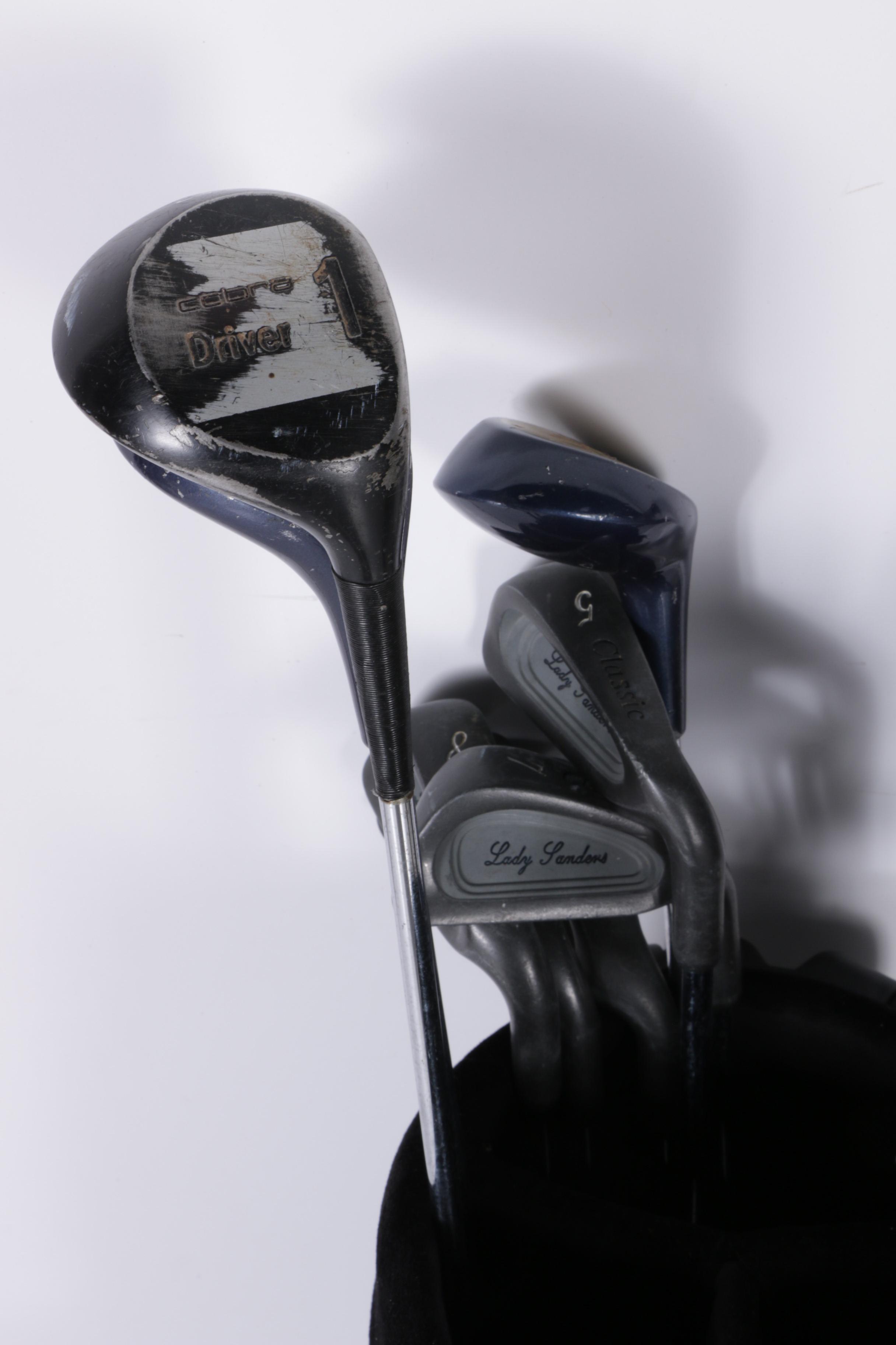 Various Golf Clubs with a Pair of Cases