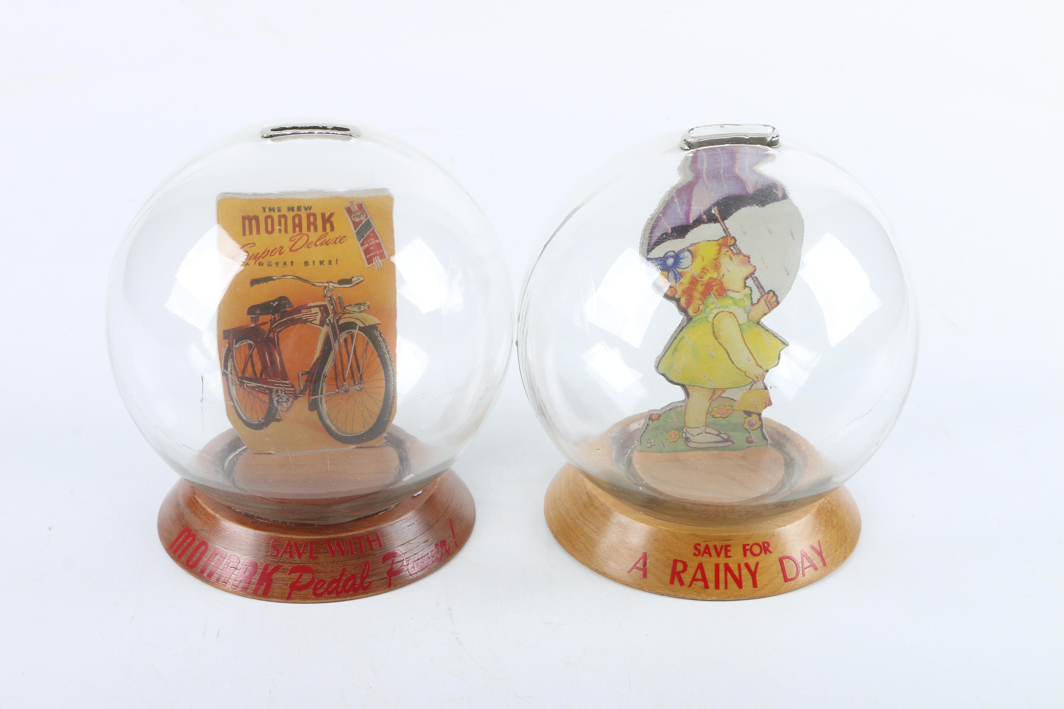 Vintage Glass Novelty Bubble Banks "Monark Pedal Power" and "A Rainy Day"